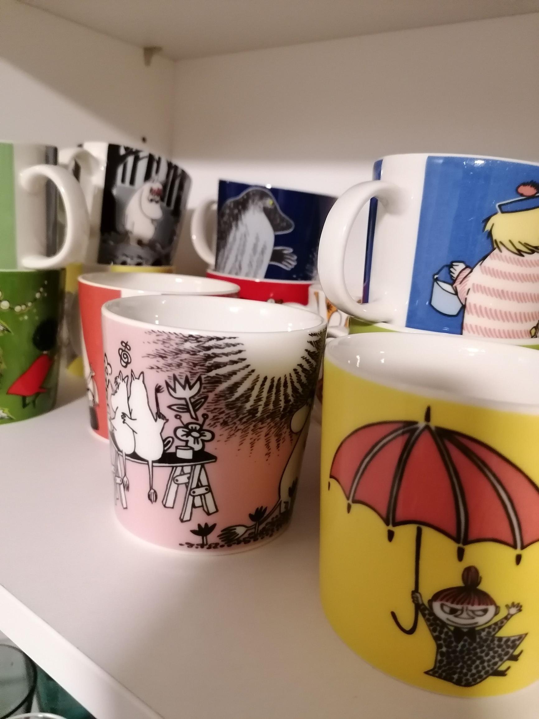 A close-up of colorful Moomin mugs
