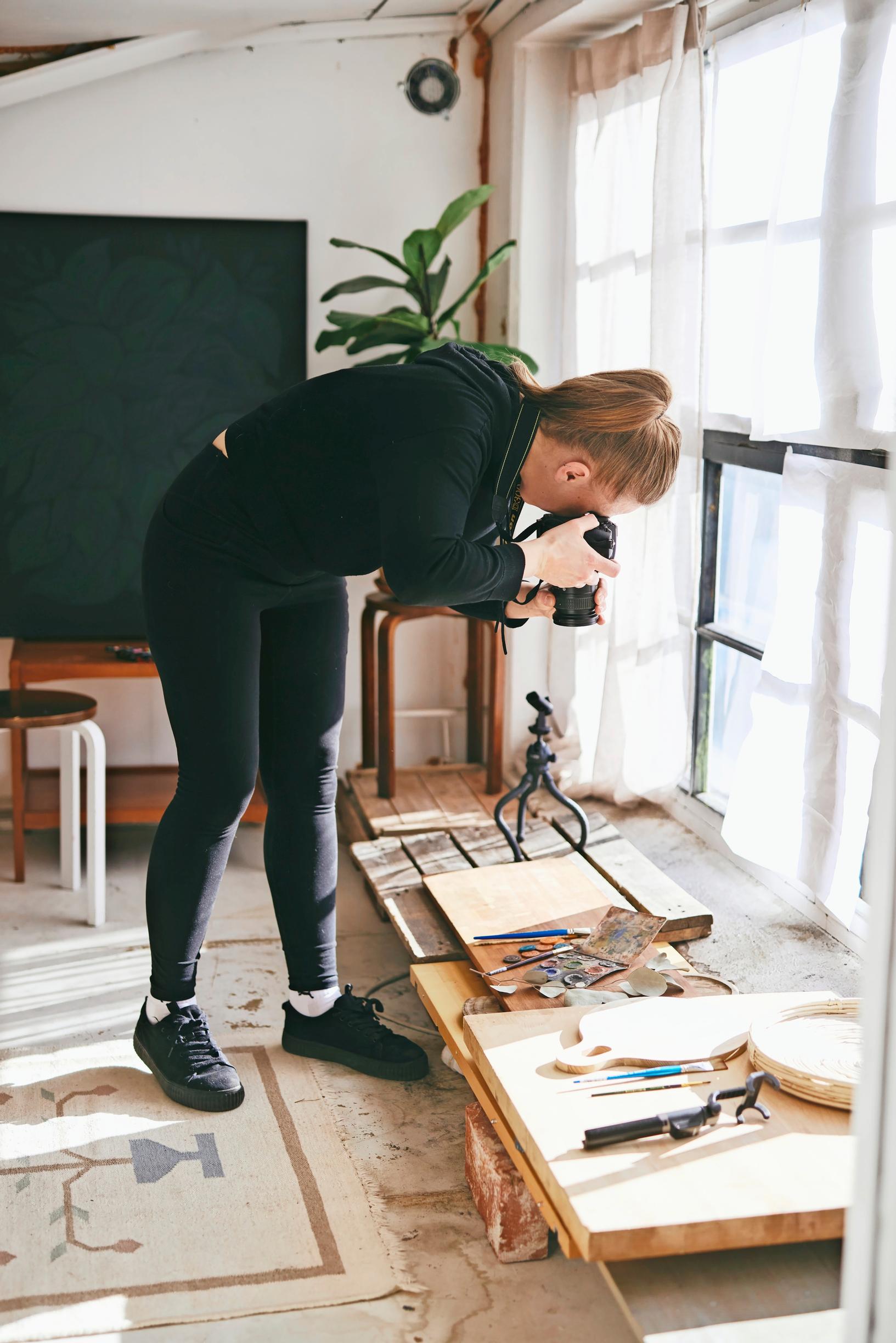 A photo of a woman taking pictures of the shop’s product range.