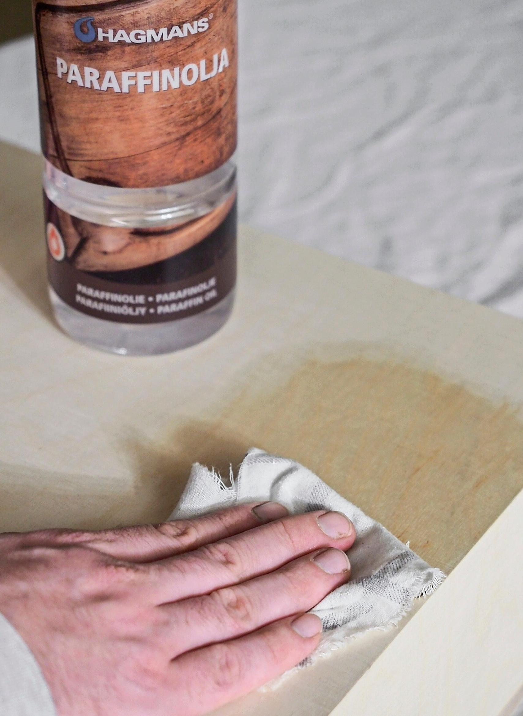 Treating the surfaces of the bedside table with paraffin oil