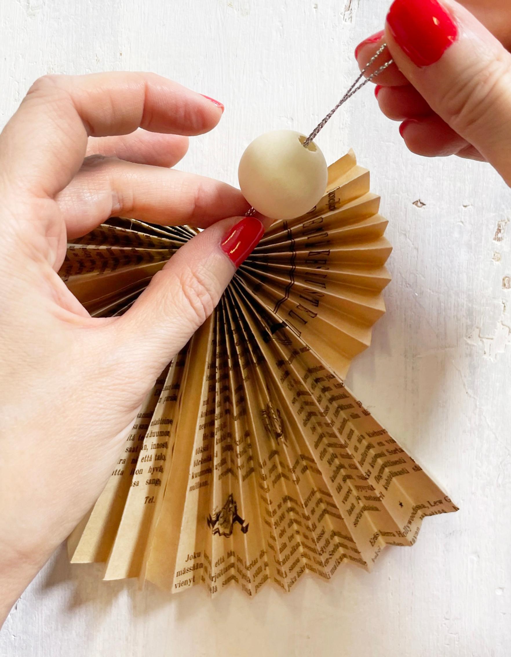 Threading a wooden bead onto the hanging loop