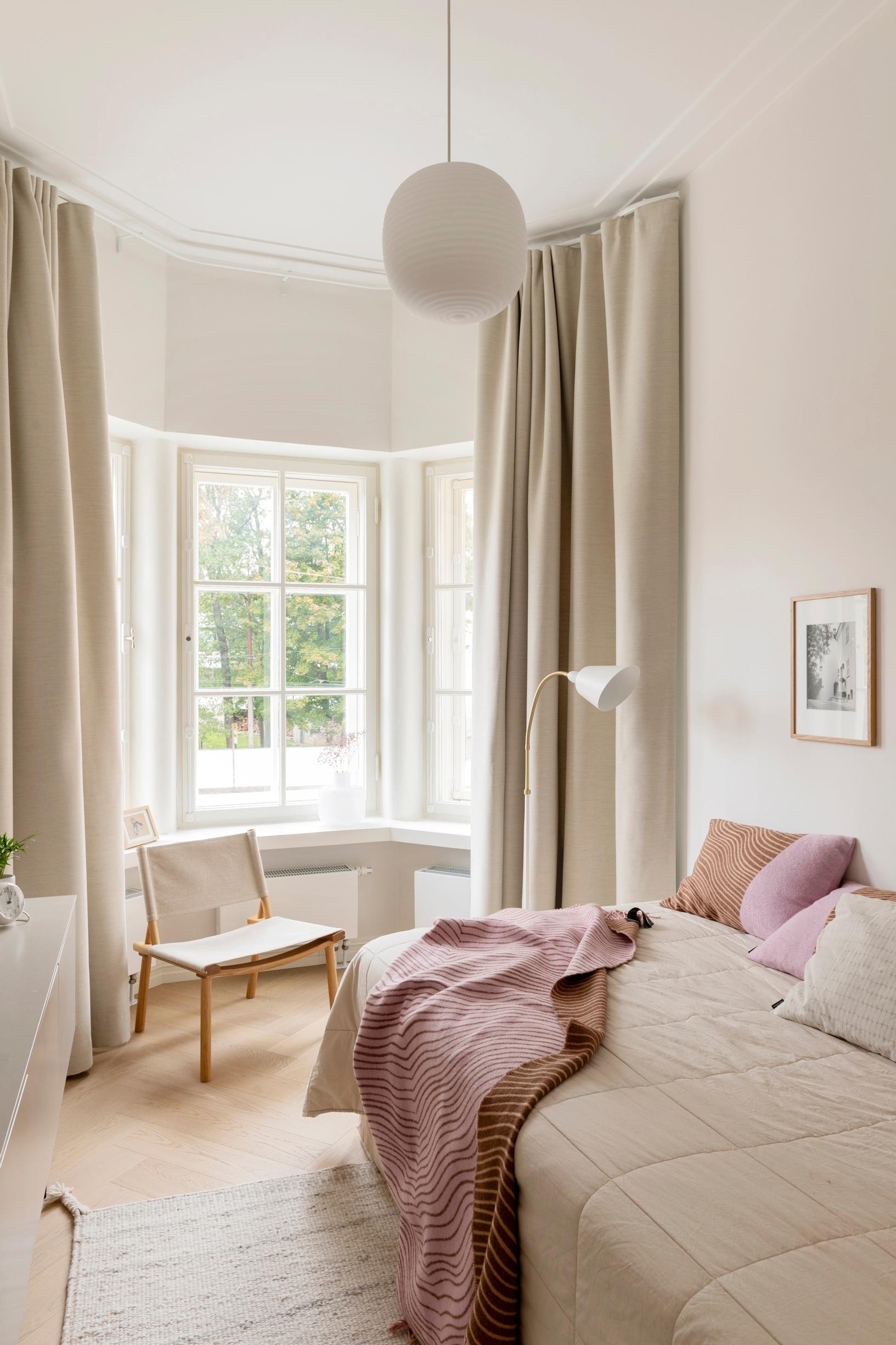 Blackout curtains following the shape of the bay window