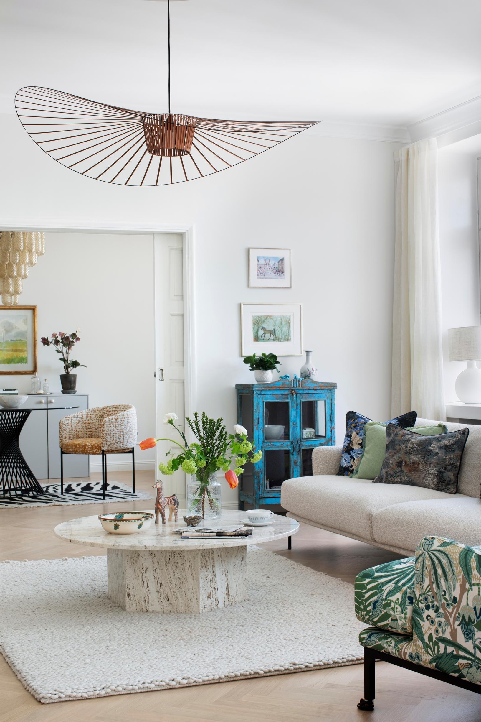 The spacious living room is the heart of the apartment, with furniture arranged centrally to define the space.