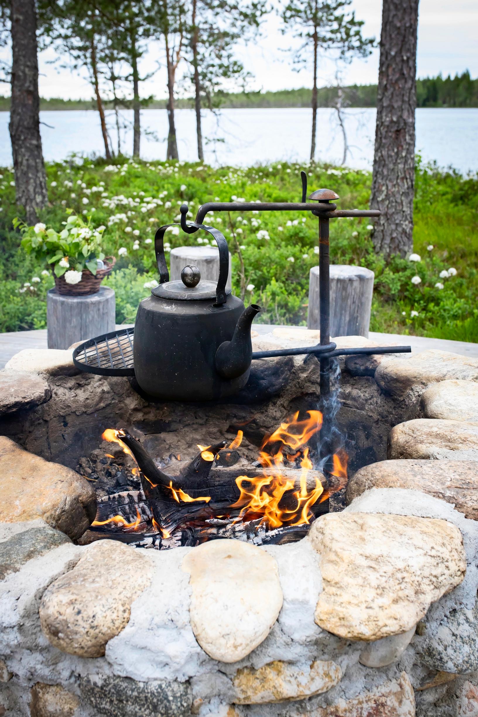 A fire pit built from natural stones by the lake