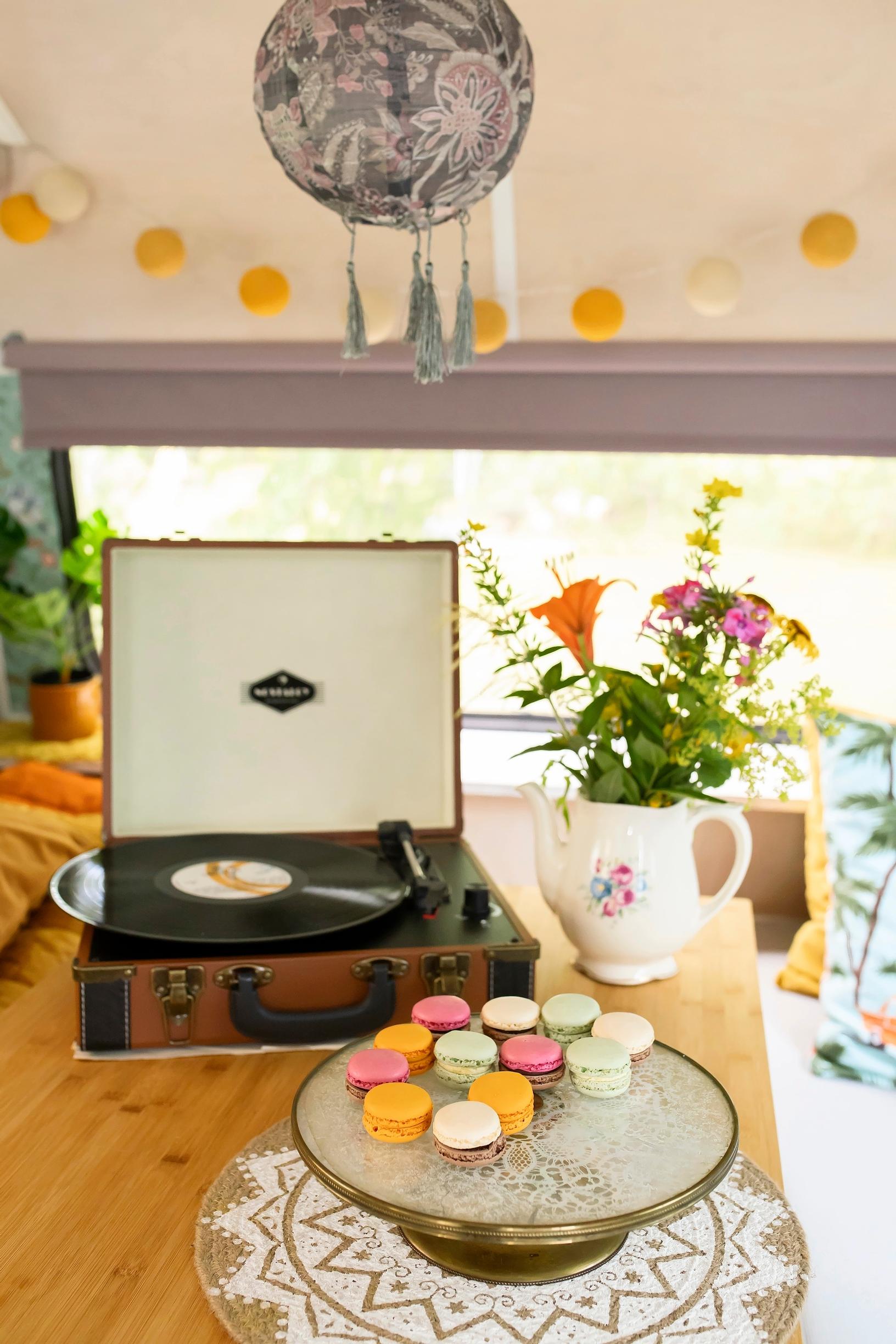 Record player, vase, and macarons