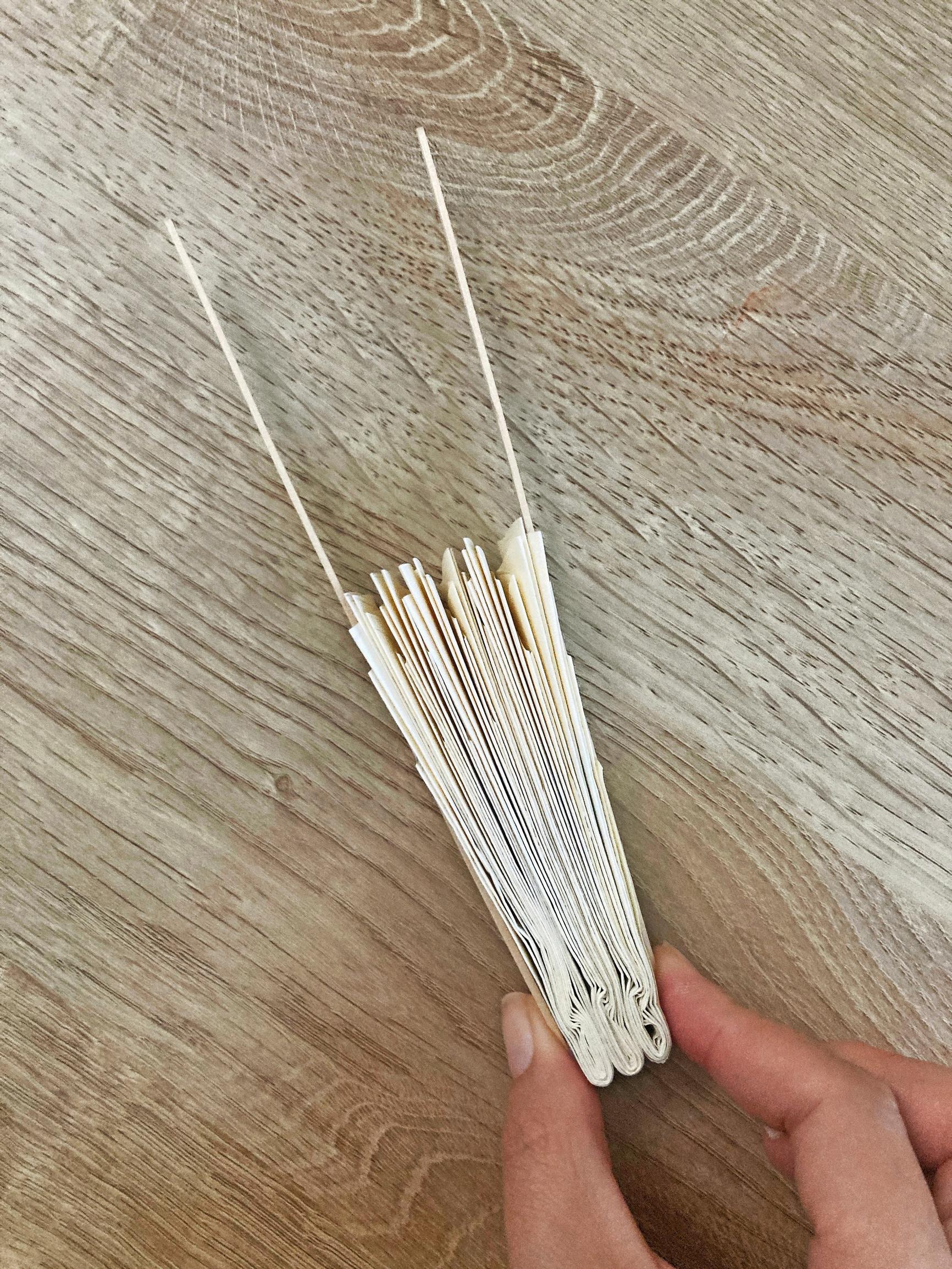 Step-by-step image of attaching the craft sticks.