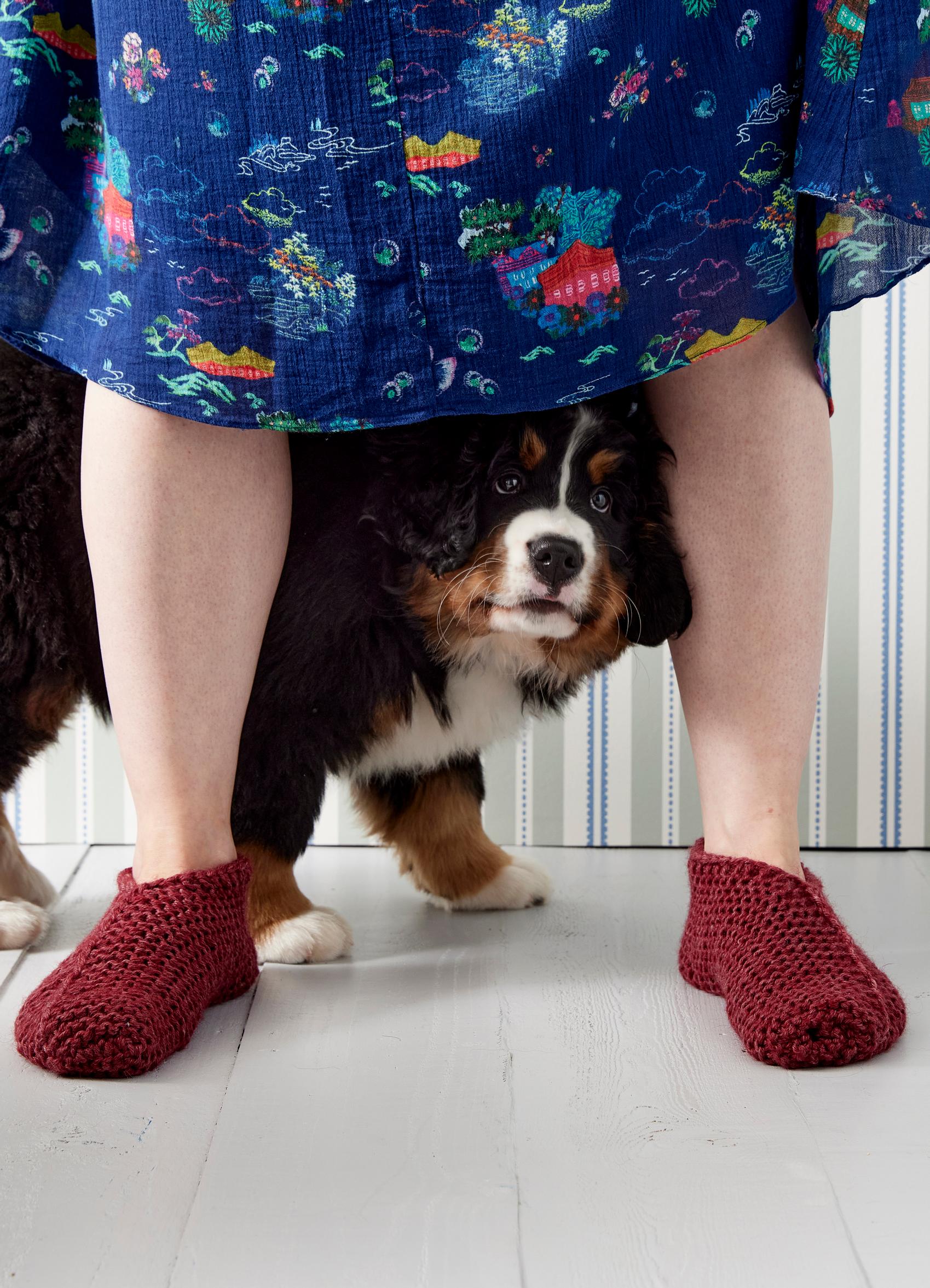 Knitted slippers on the model’s feet