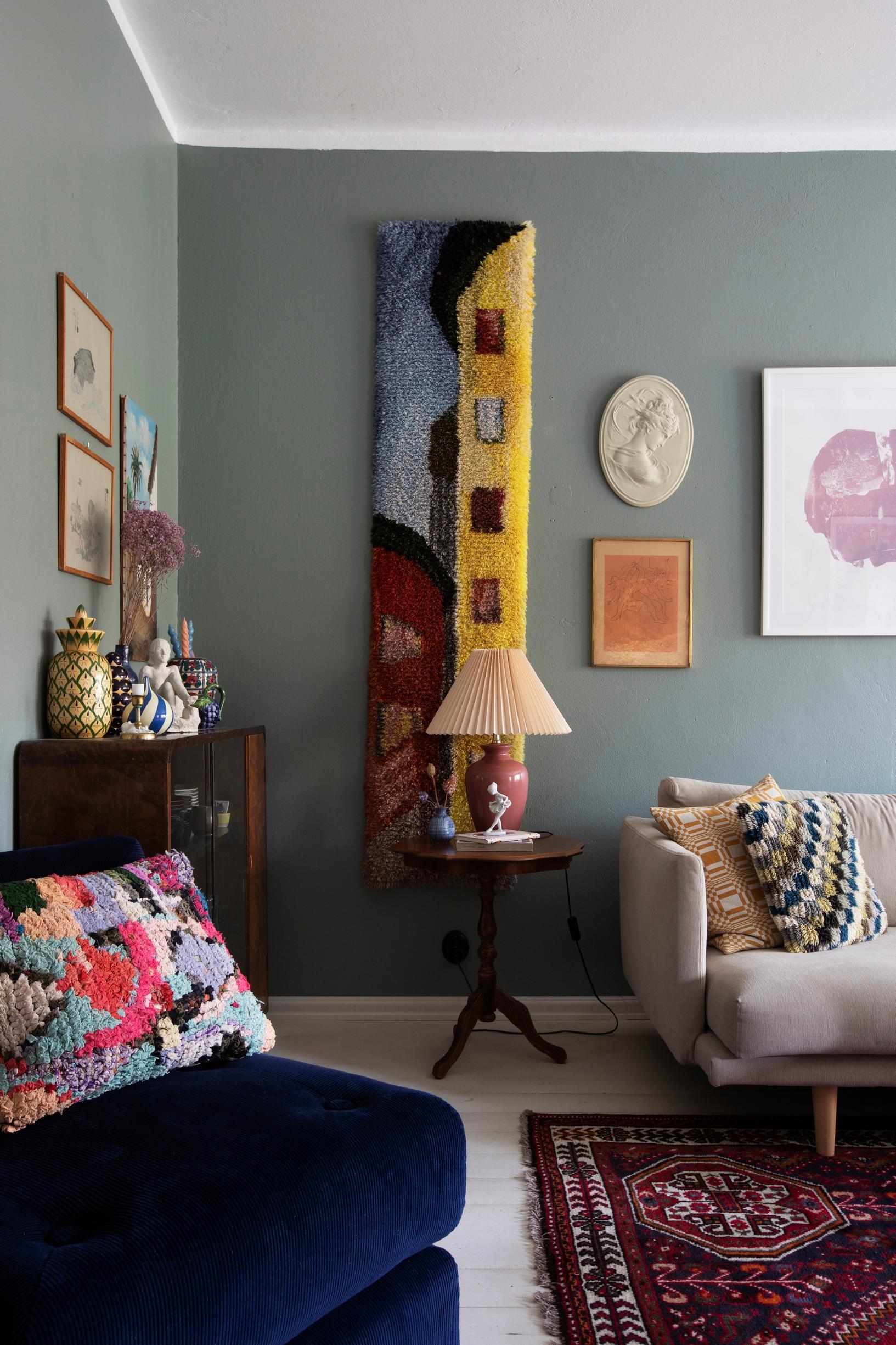 A ryijy pillow and a wall tapestry add color to the reading corner