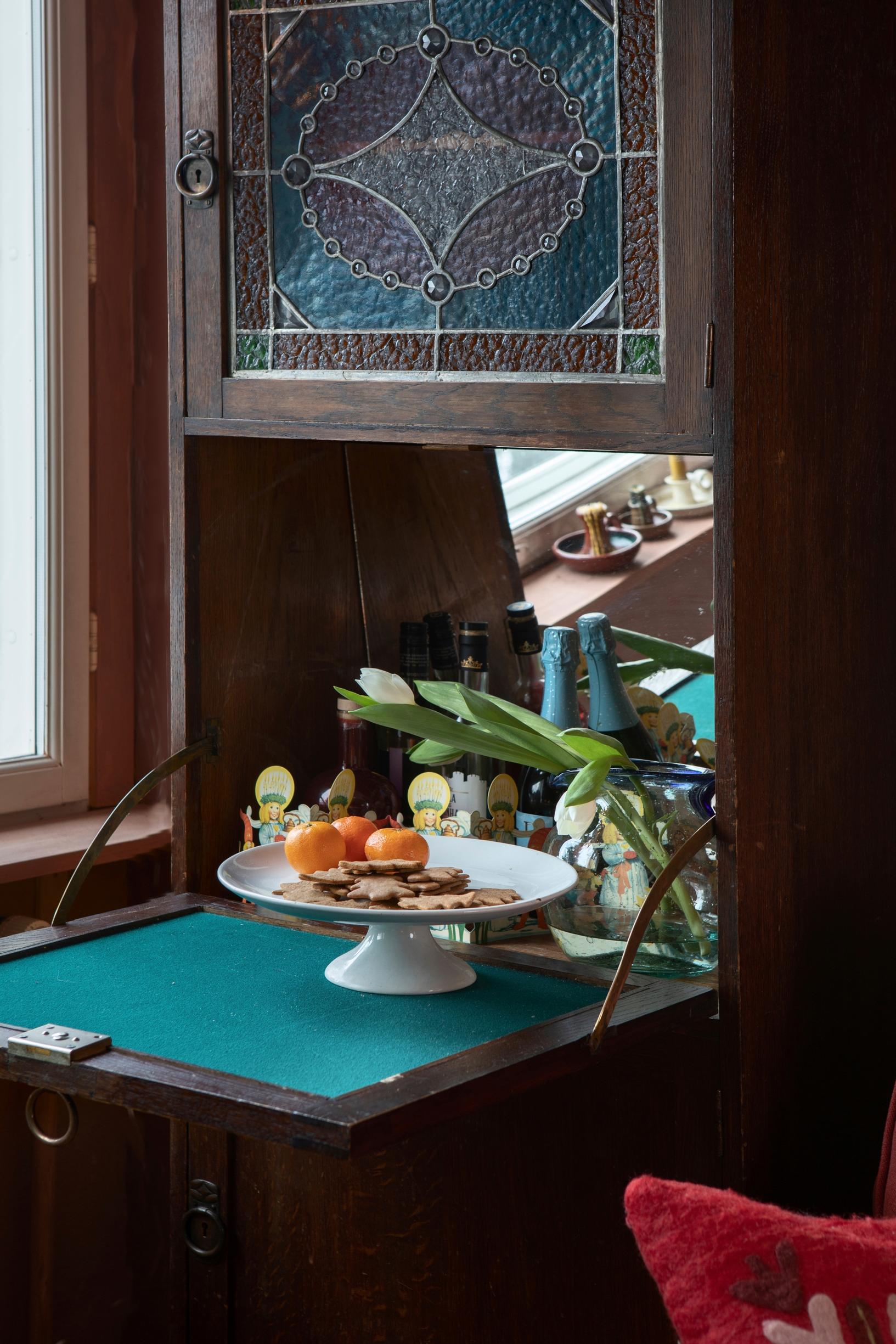 Drop-front cabinet with Tiffany glass