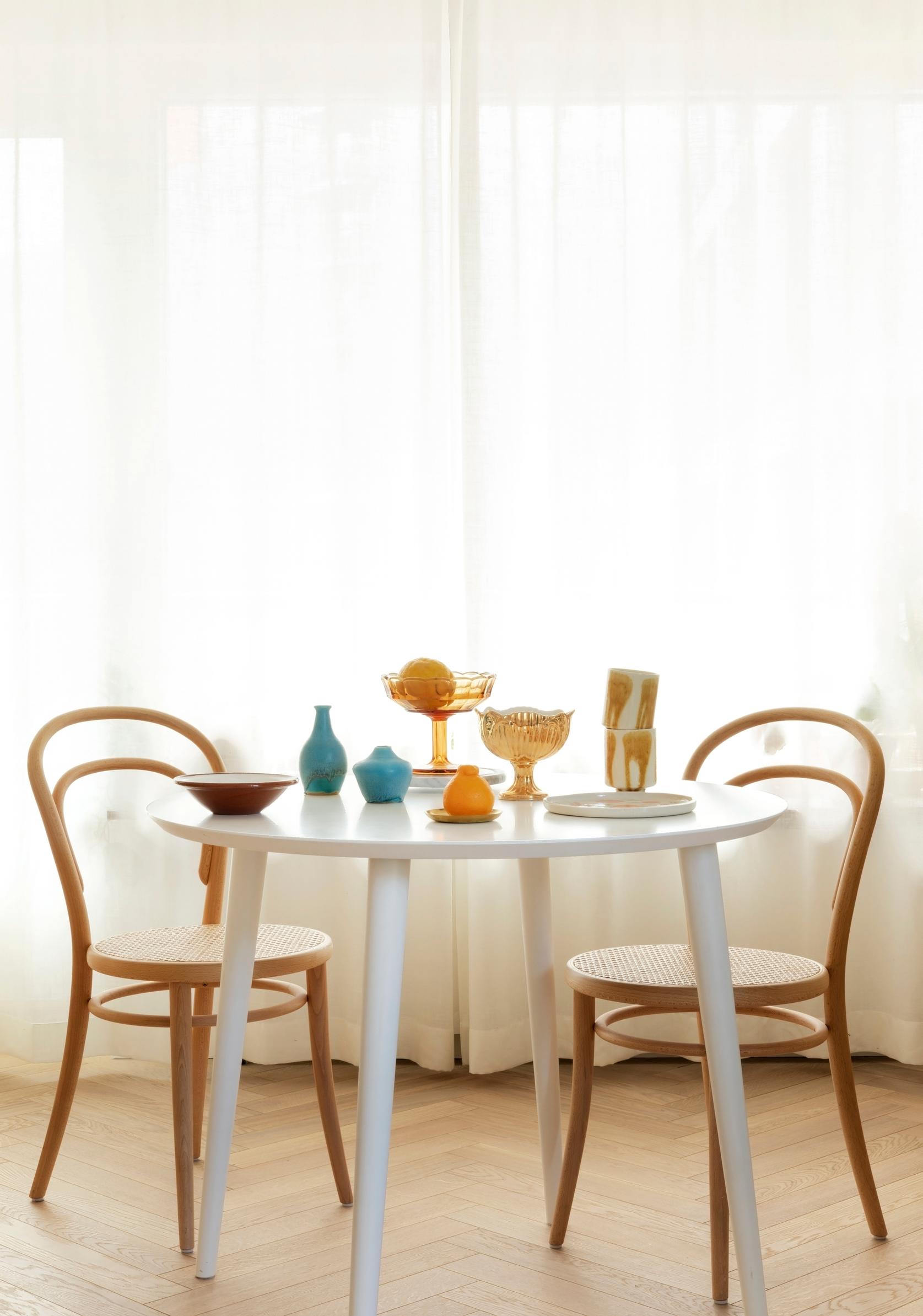 Full-length linen sheer curtains in a dining area