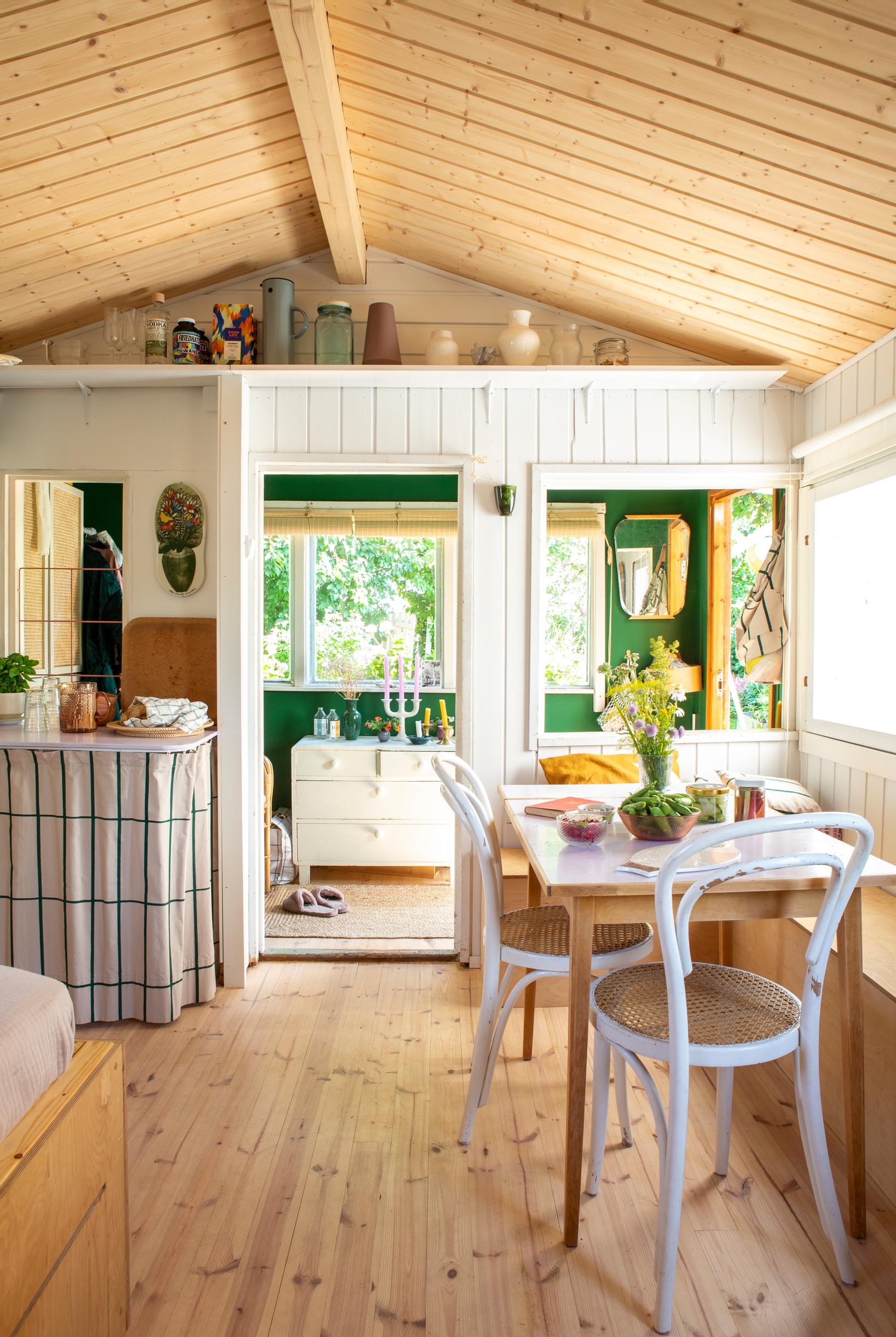 A green-painted back wall brings a burst of energy to a cottage interior.