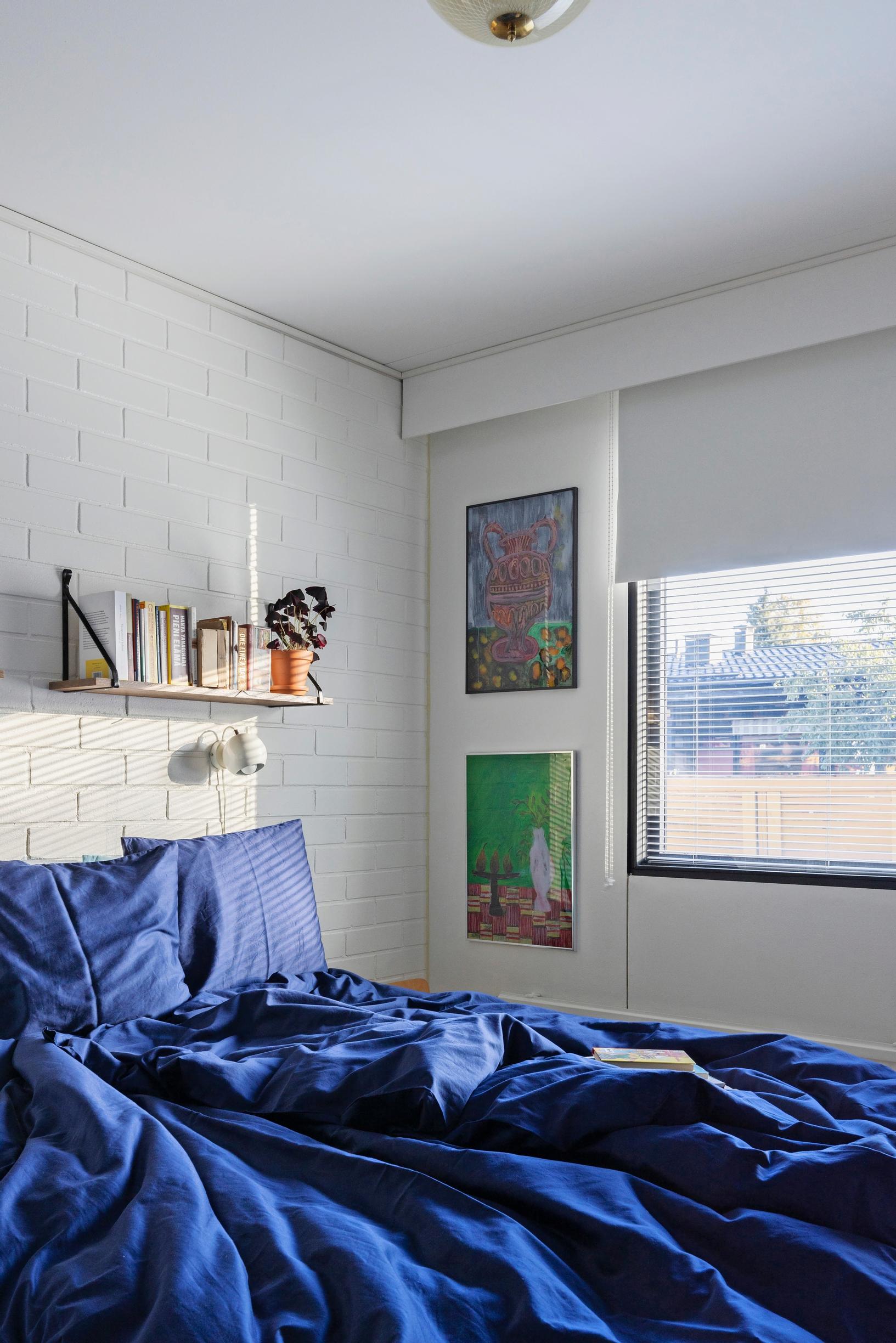 Photo of the bedroom with blue sheets.