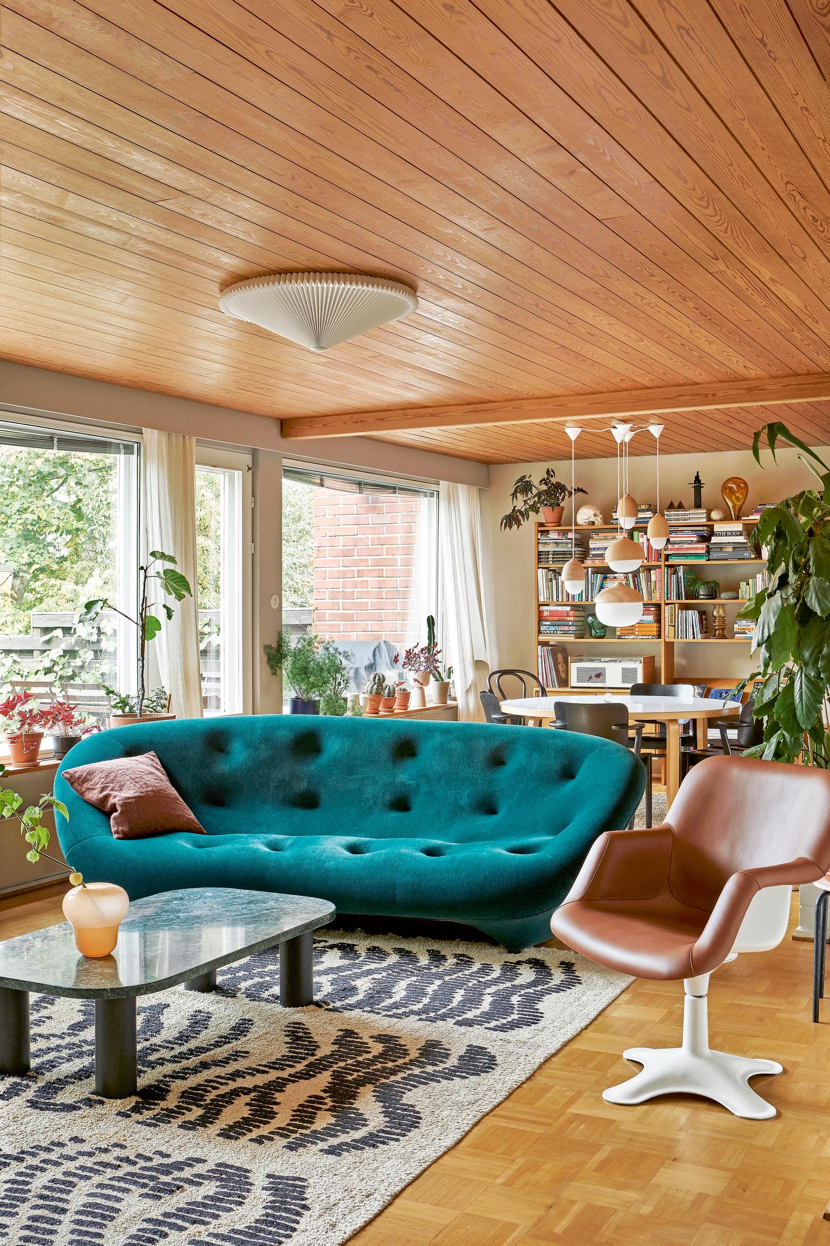 An open living and dining area overlooks the garden, with the Ploum sofa by Ligne Roset serving as the focal point.