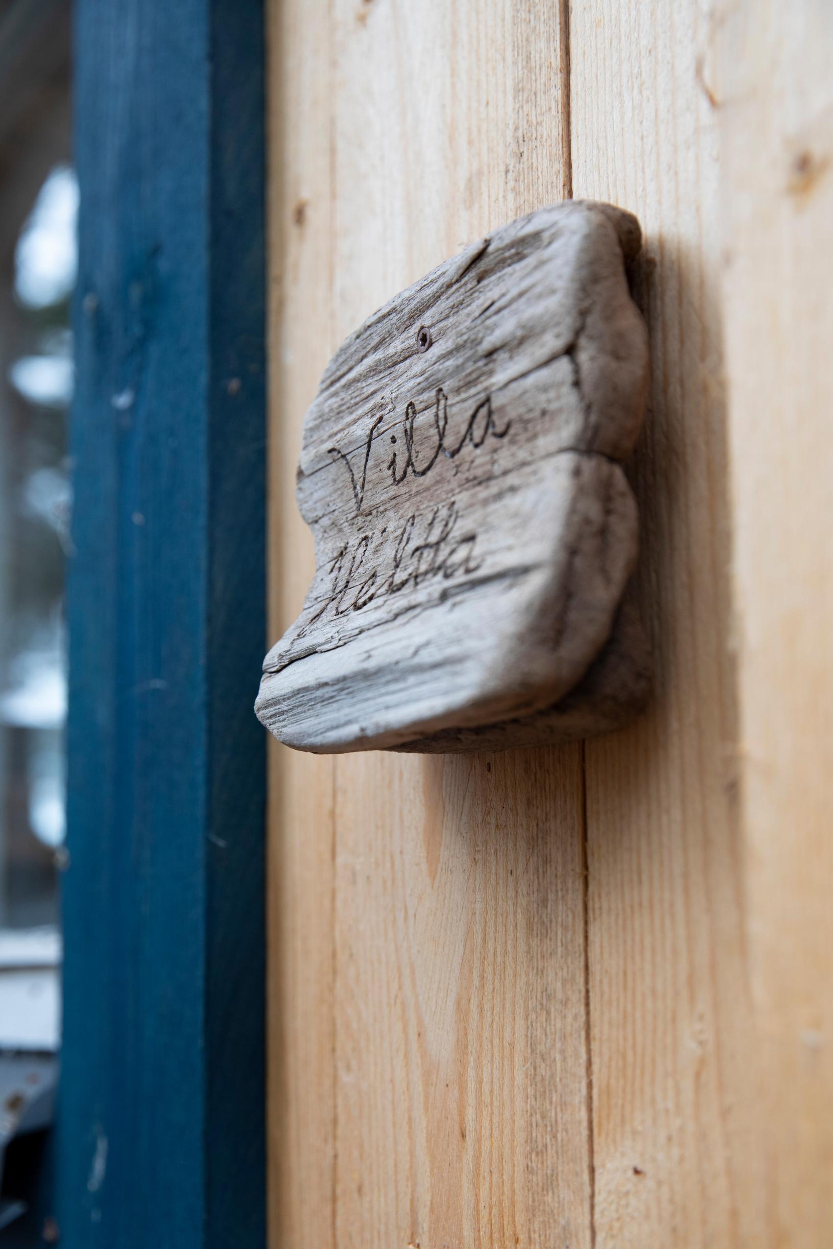 A sign on the house wall reads Villa Heltta