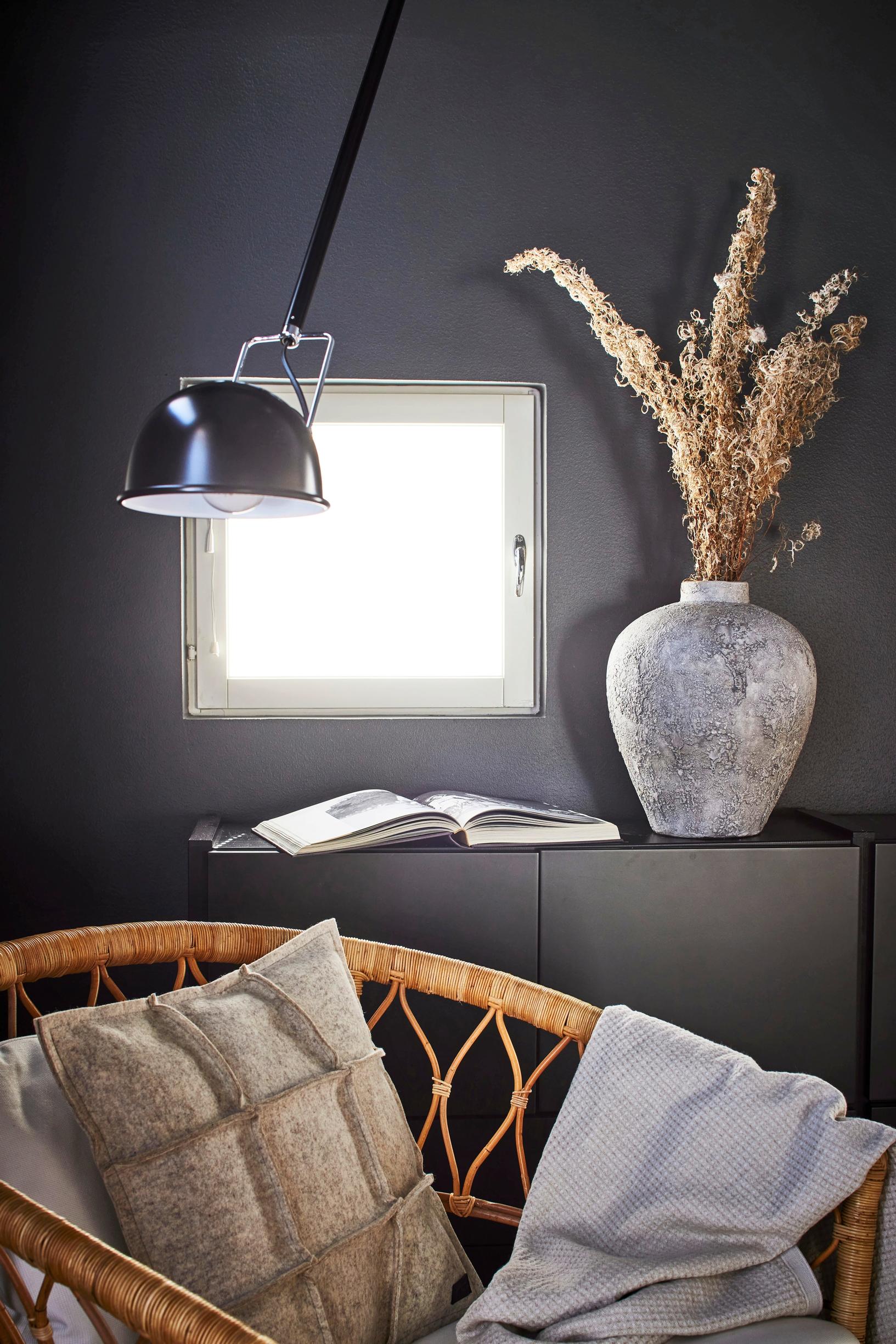 A dark gray bedroom provides a calm space for reading.