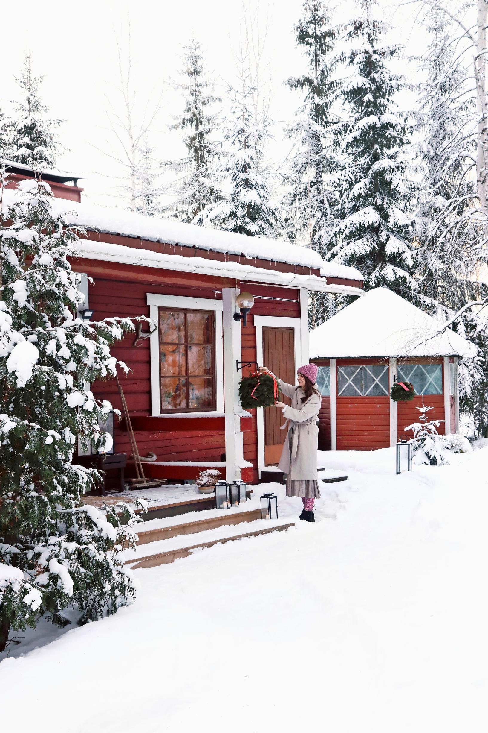 Ulla Parviainen in the snowy yard of her cabin in Pusula