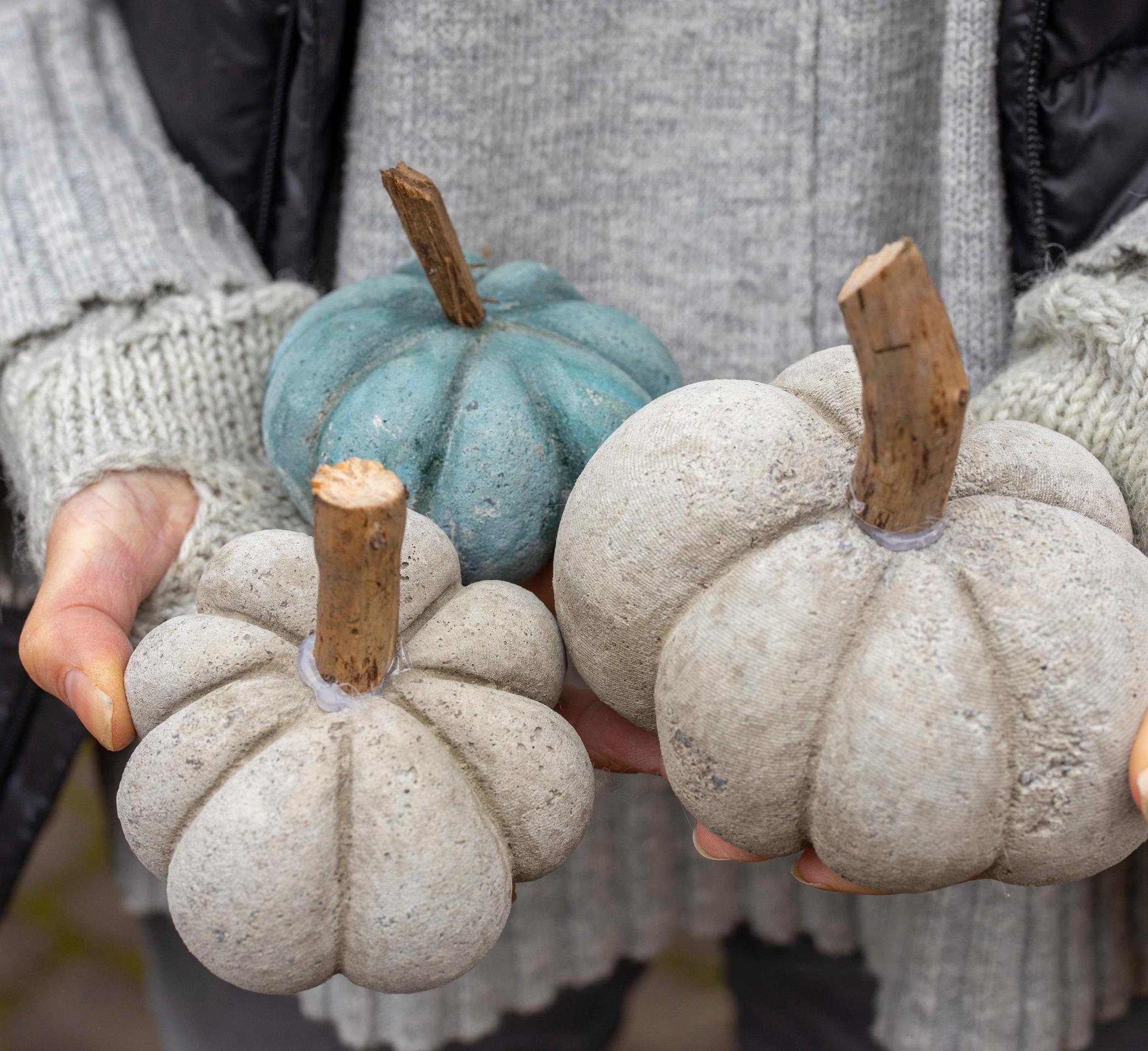 Pumpkin decorations made with pantyhose, concrete, and string.