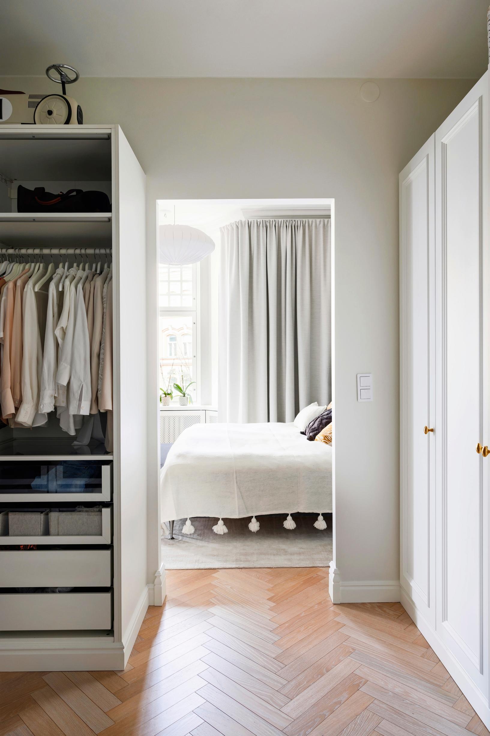 A view from the walk-in closet into the parents’ bedroom.