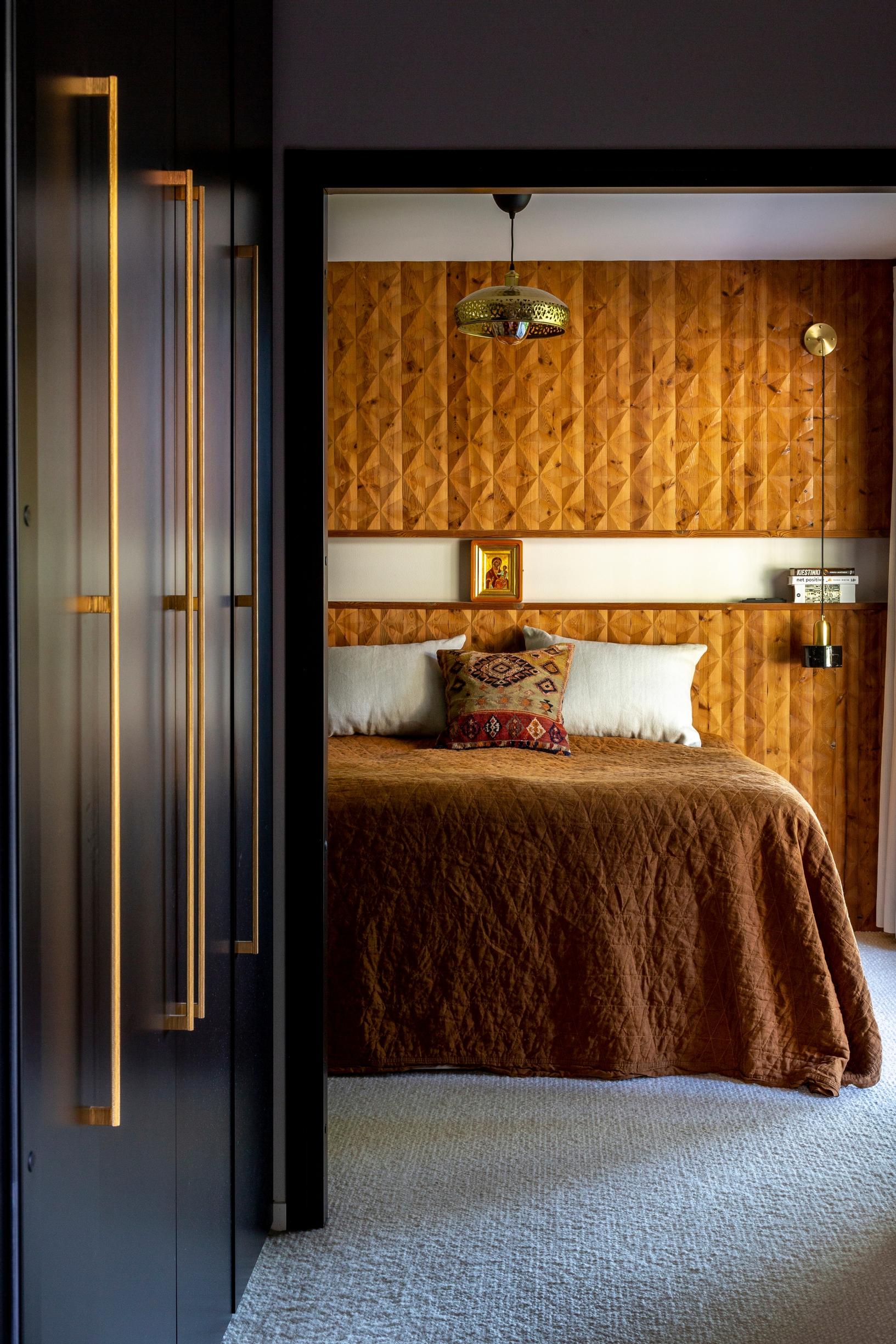 A wool, wall-to-wall carpet and warm-toned wood paneling in the sleeping area.