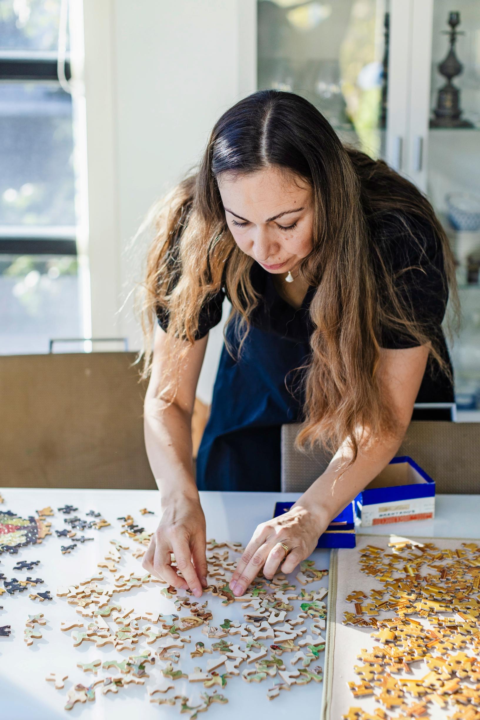 Pictured: jigsaw puzzle enthusiast Kira Rainvuori working on a puzzle.