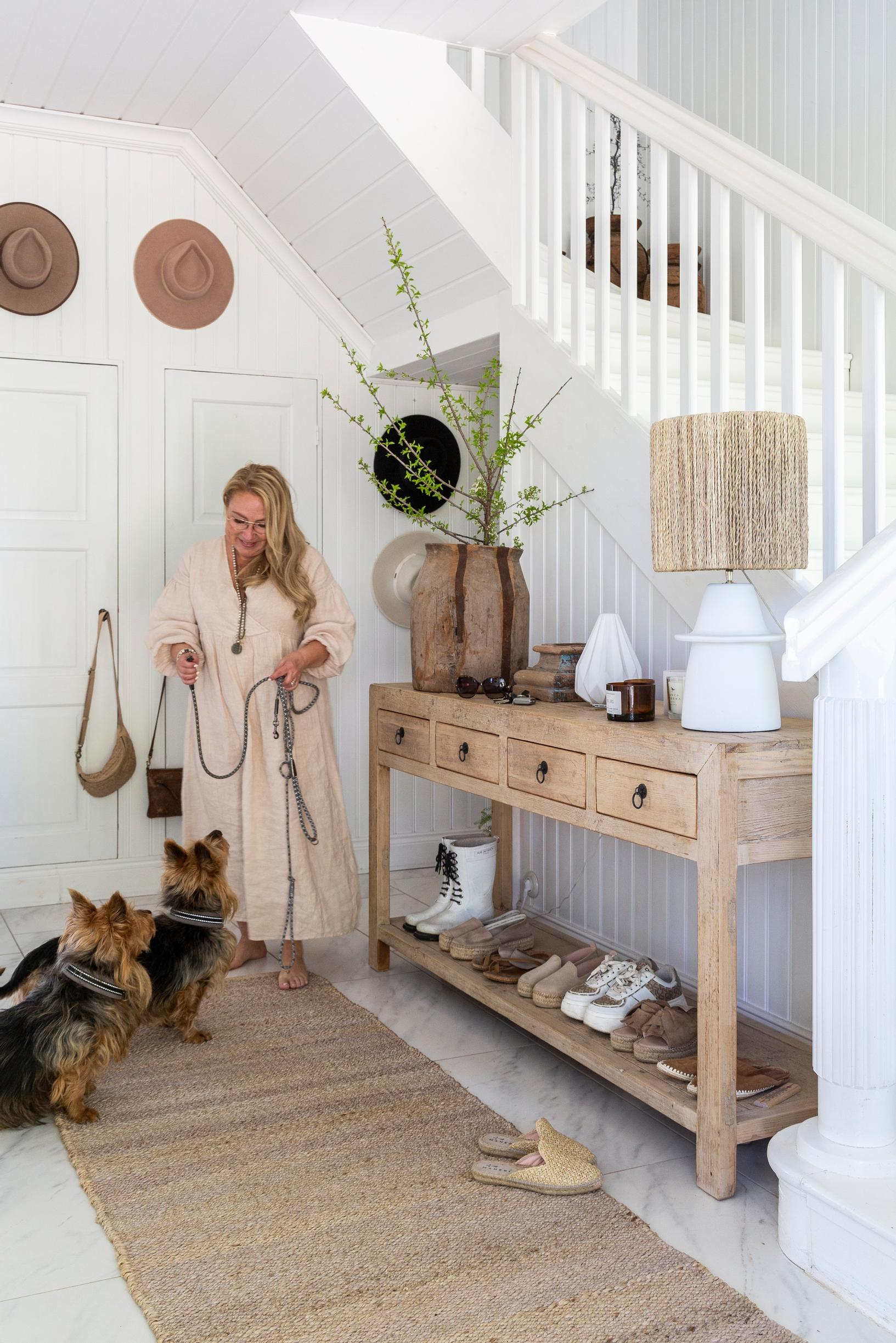 Pia Erlund in the hallway with her two Australian Terriers