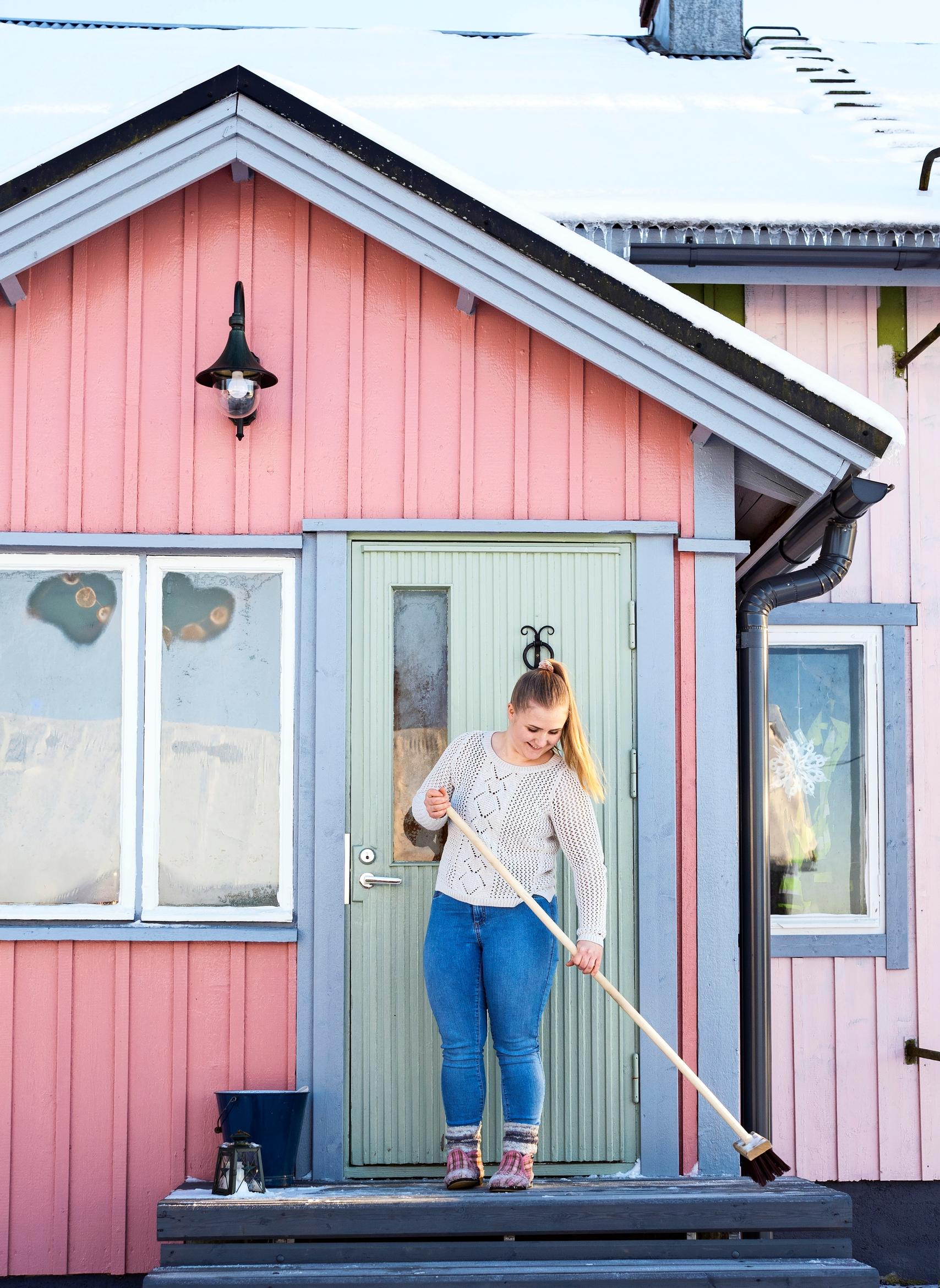 A woman sweeping the stairs