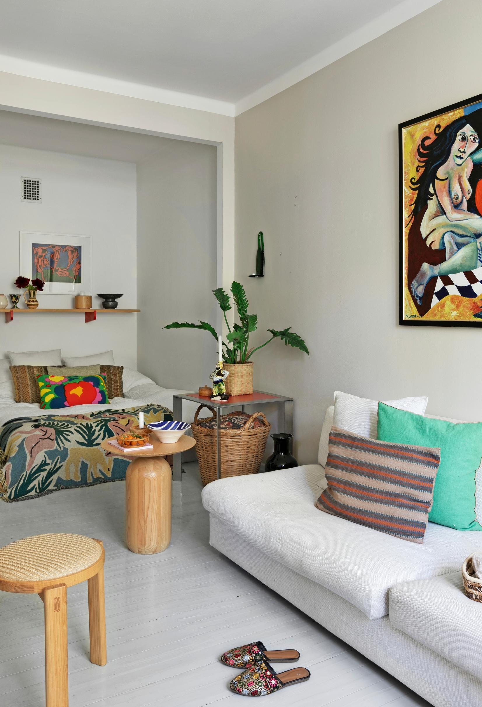 Small furnishings and a light-colored sofa in a long, narrow living room
