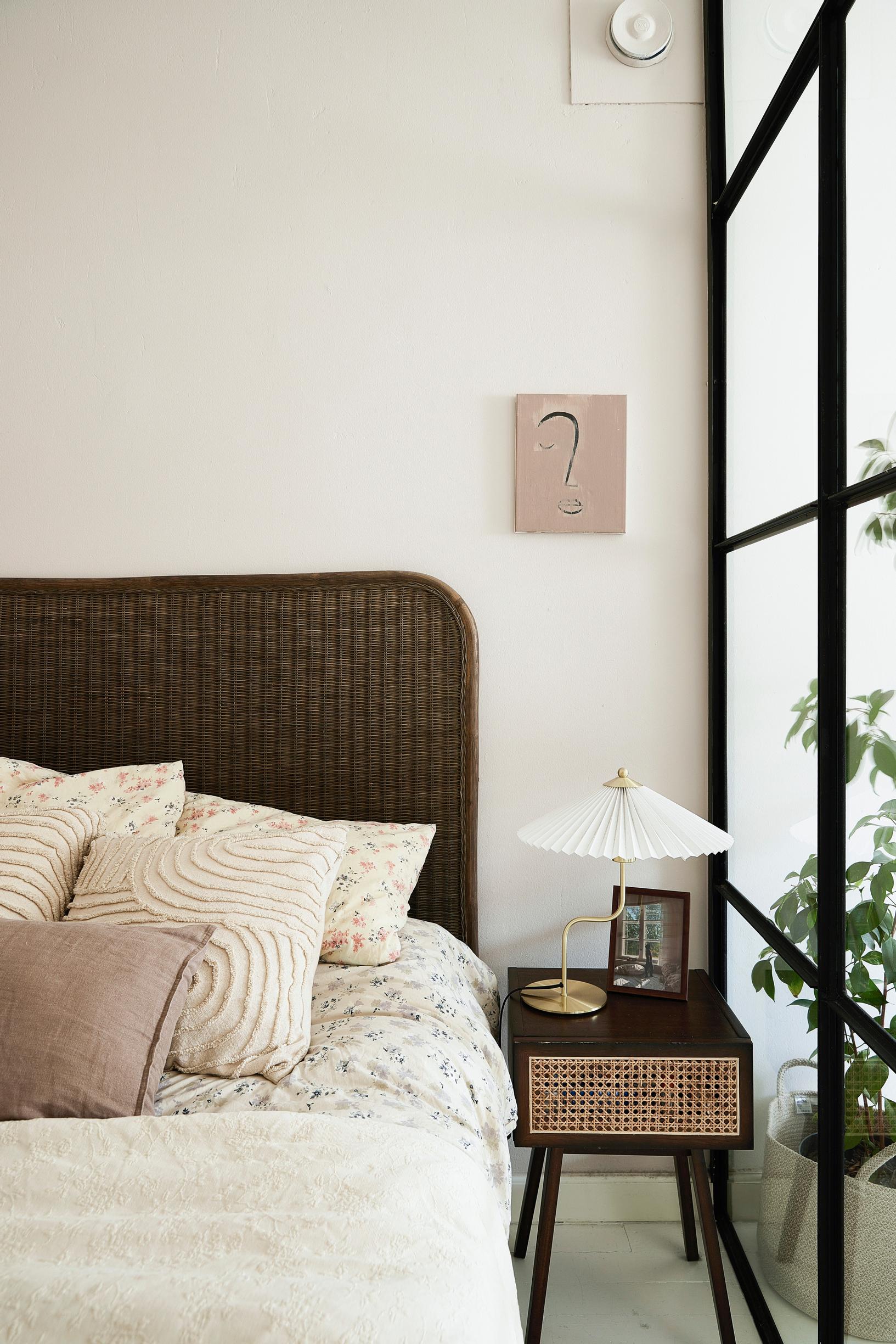 A sleeping area with a dark brown headboard