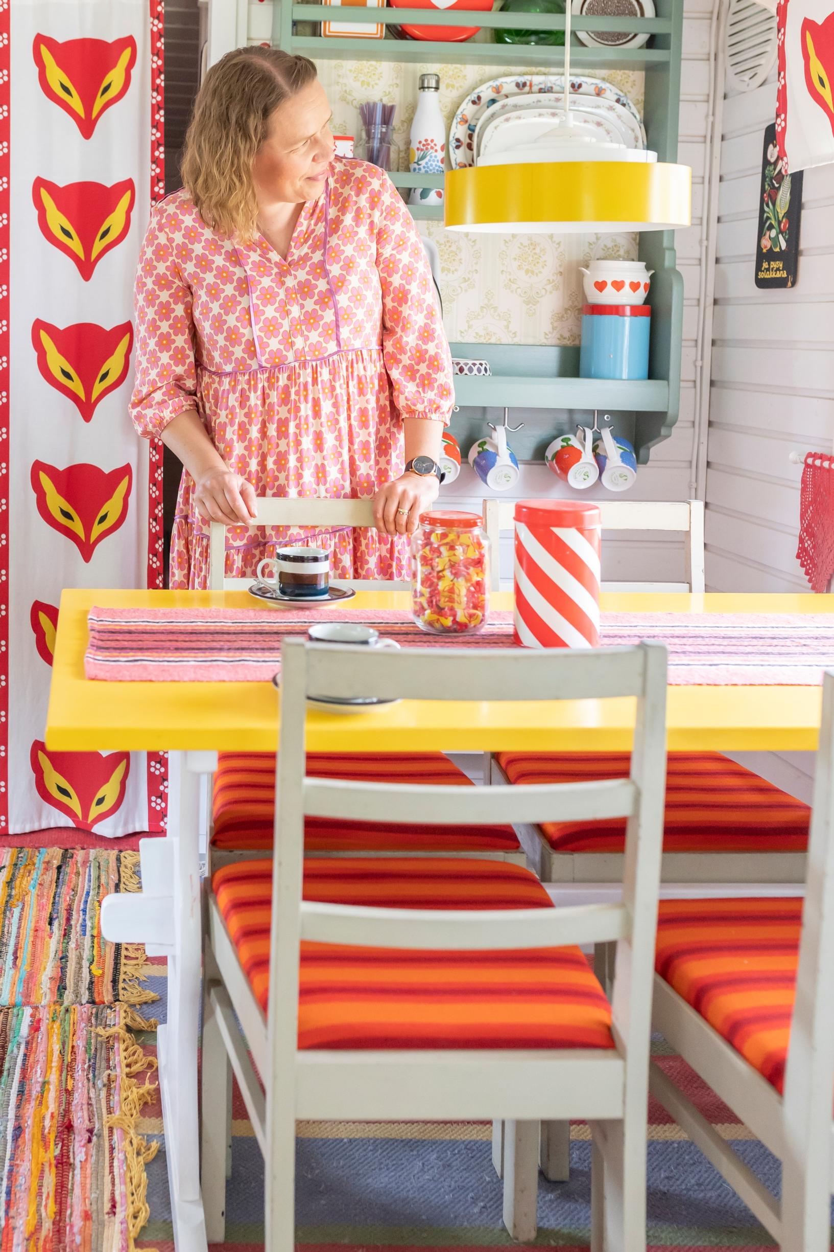 a Kettukarkki curtain, with Leni Joutsjoki standing by the table and a dining set
