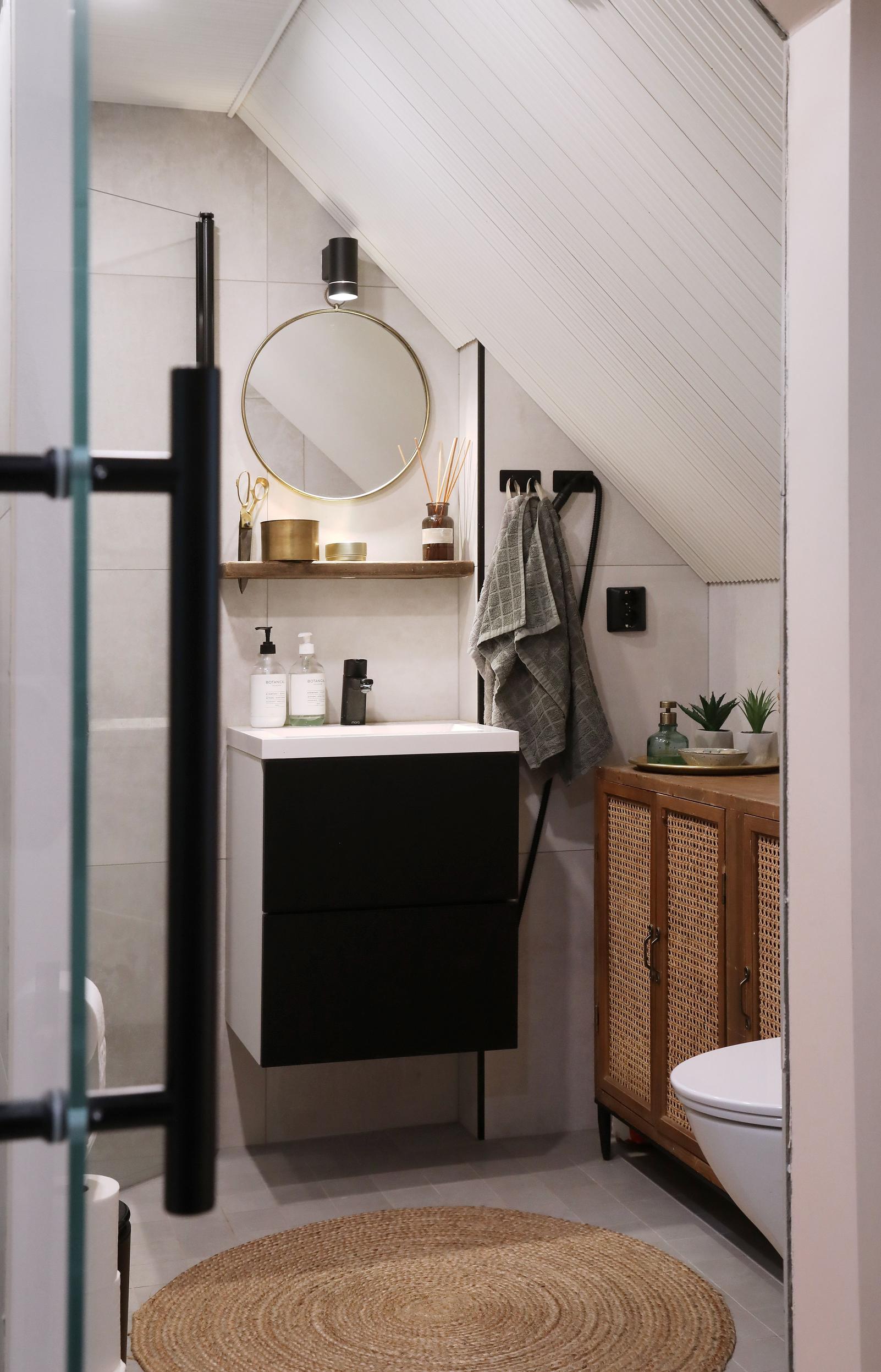 The bathroom has a sloped ceiling.