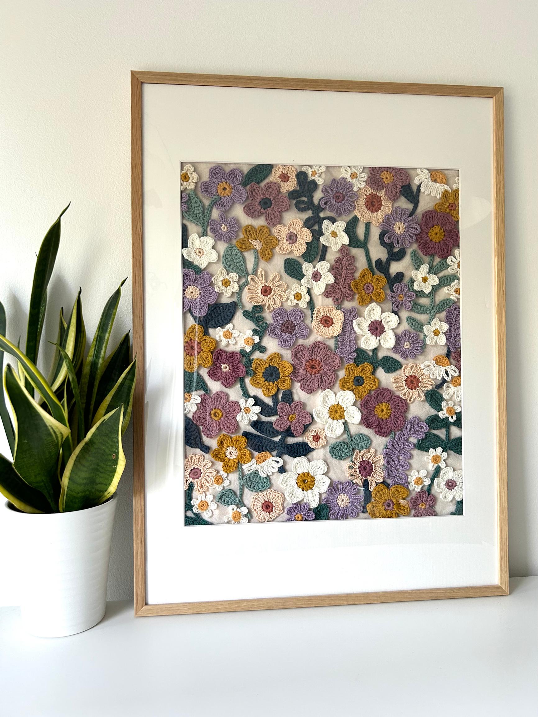The finished painting, framed, on top of a sideboard.