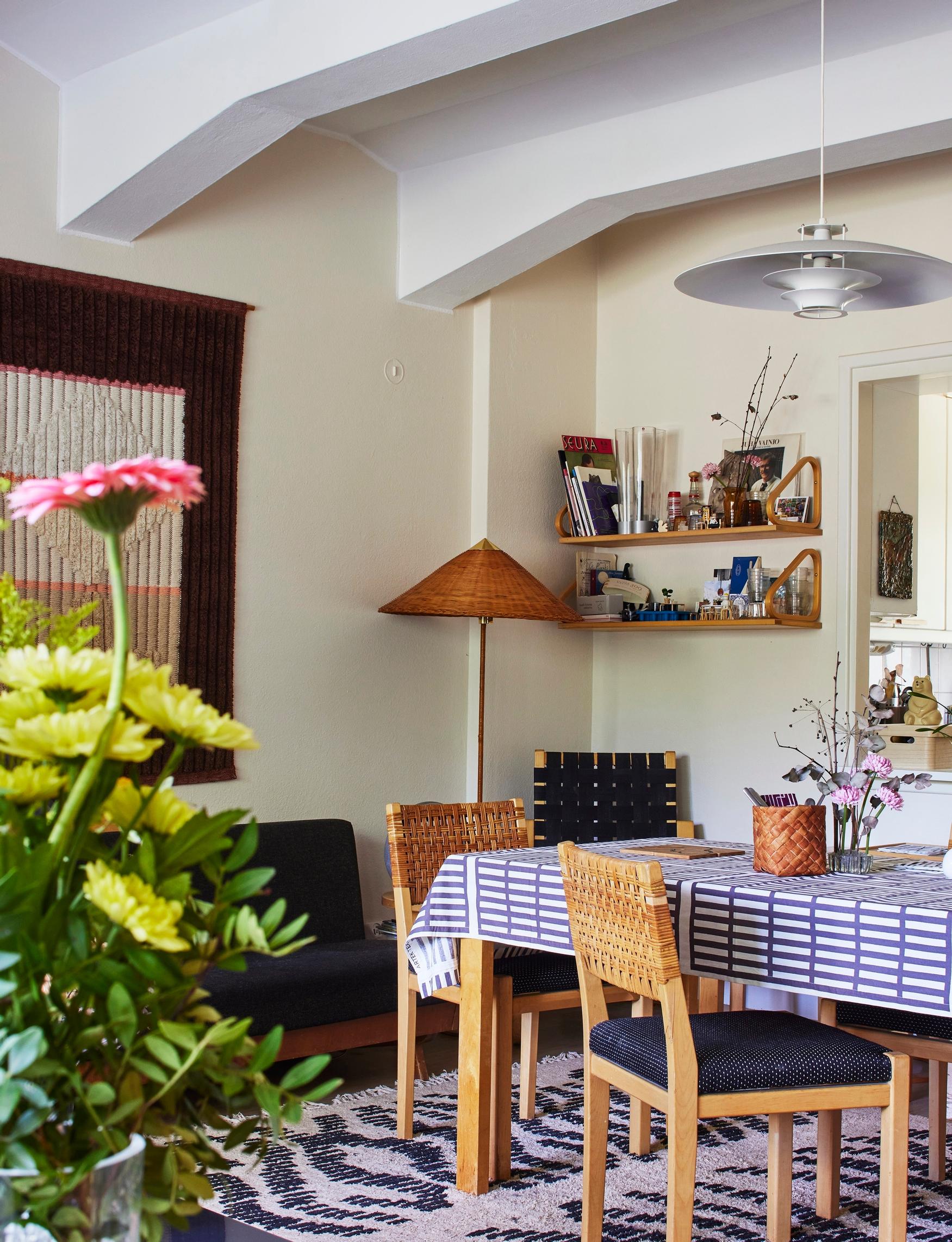 A window connects the living room and kitchen in a home furnished with Artek and vintage pieces.