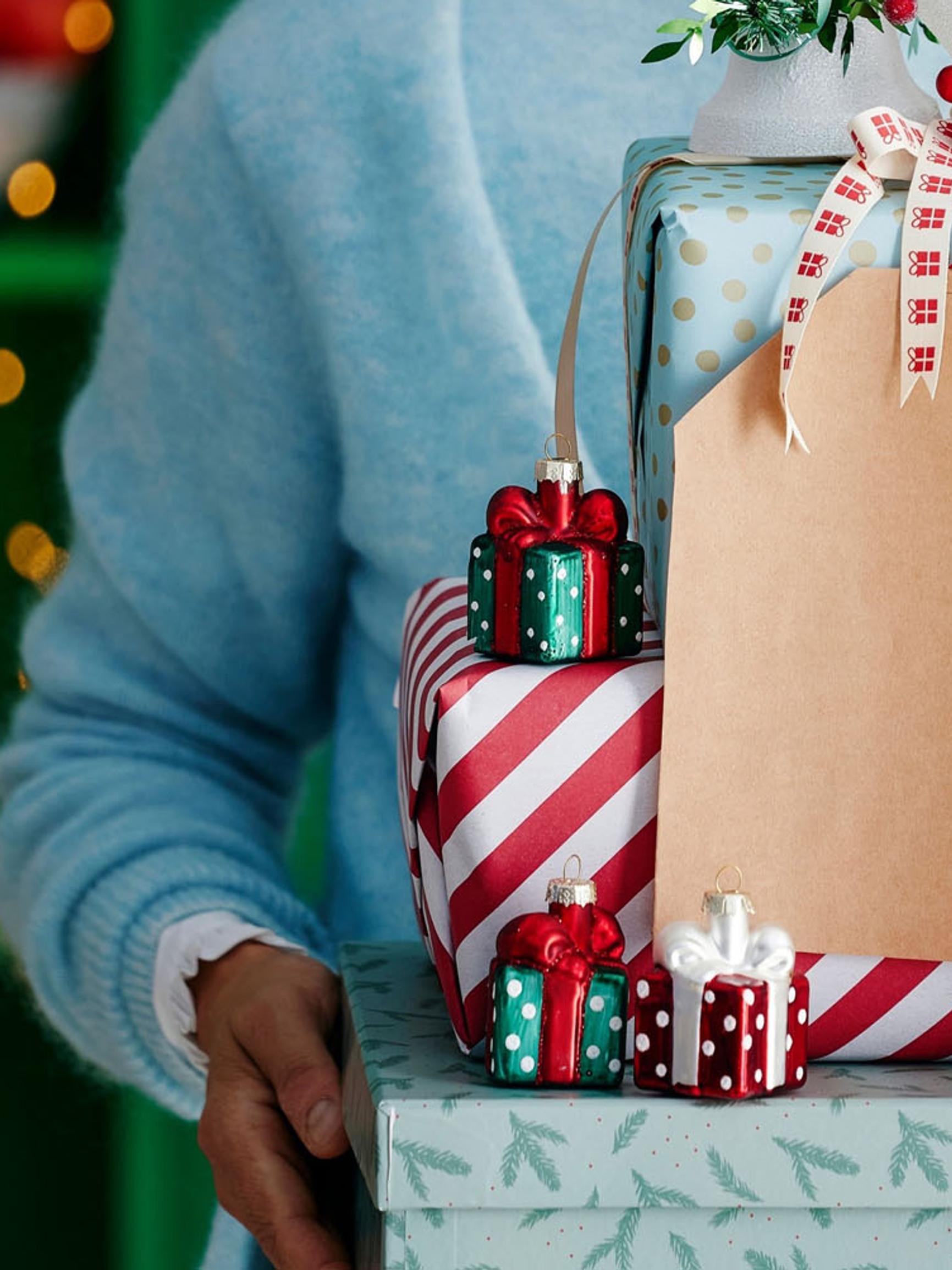 Beautiful gift wrapping from reused materials: a toilet paper roll package, customized glass jar, and hand-drawn bow