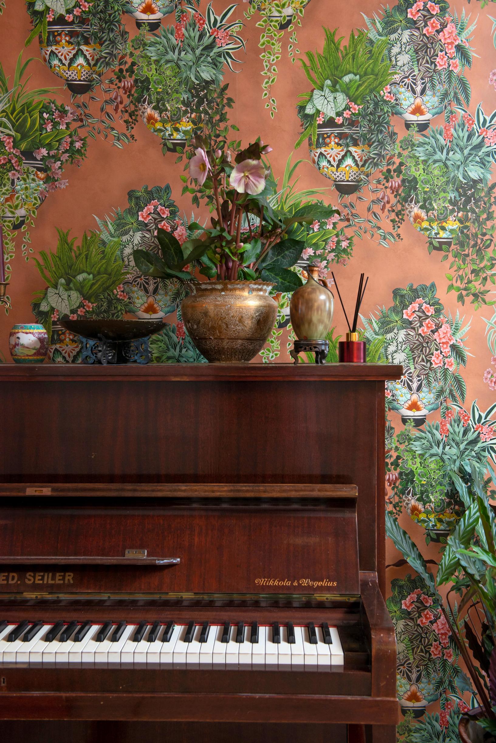 Downstairs wallpapered wall and an old piano.