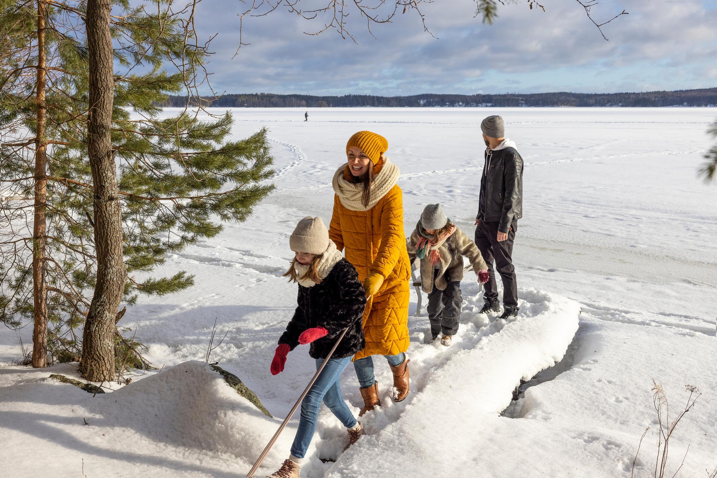 The Luomaranta family at the lakefront in winter.