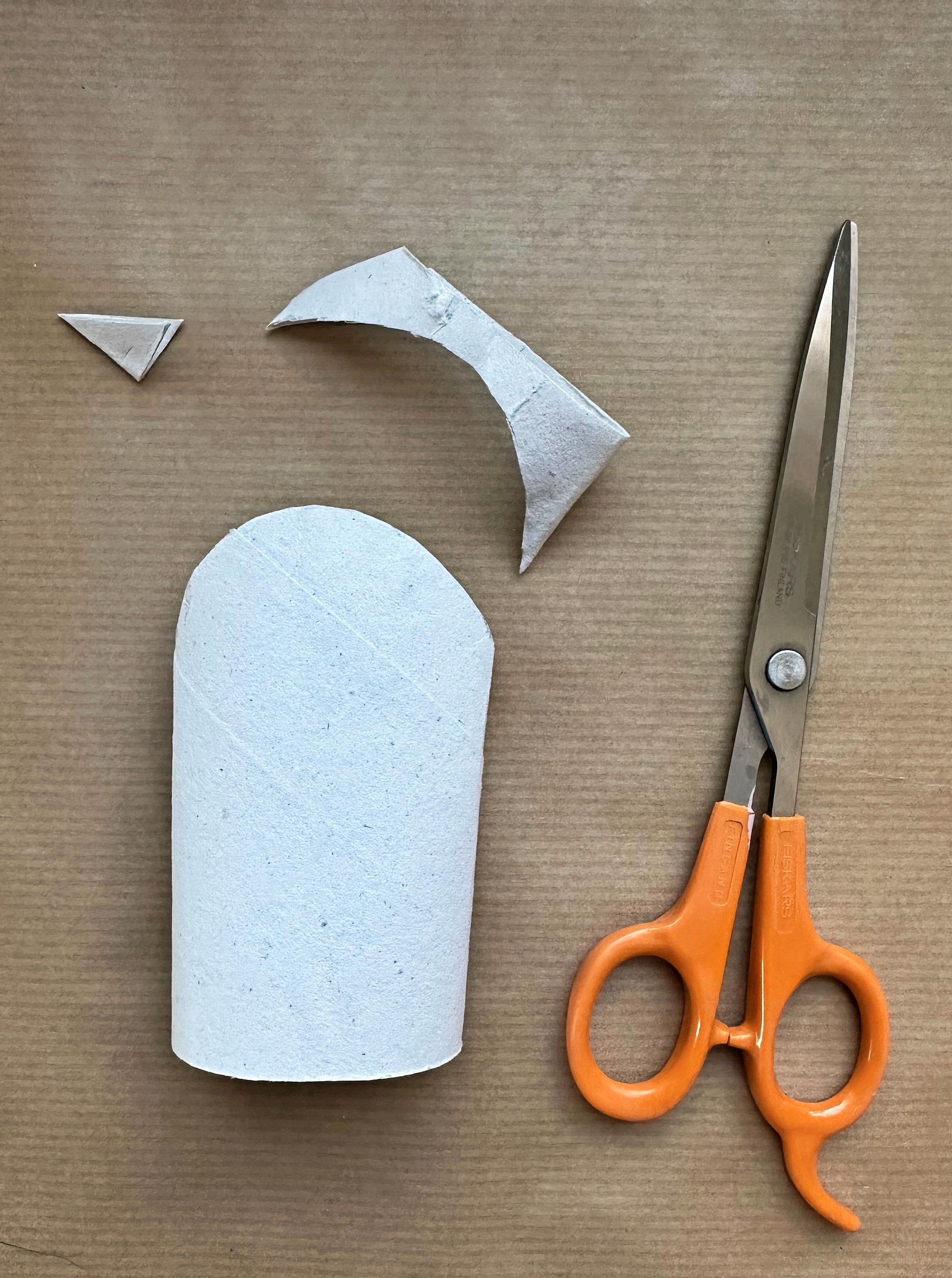 One end of the toilet paper roll has been trimmed into a curved shape.