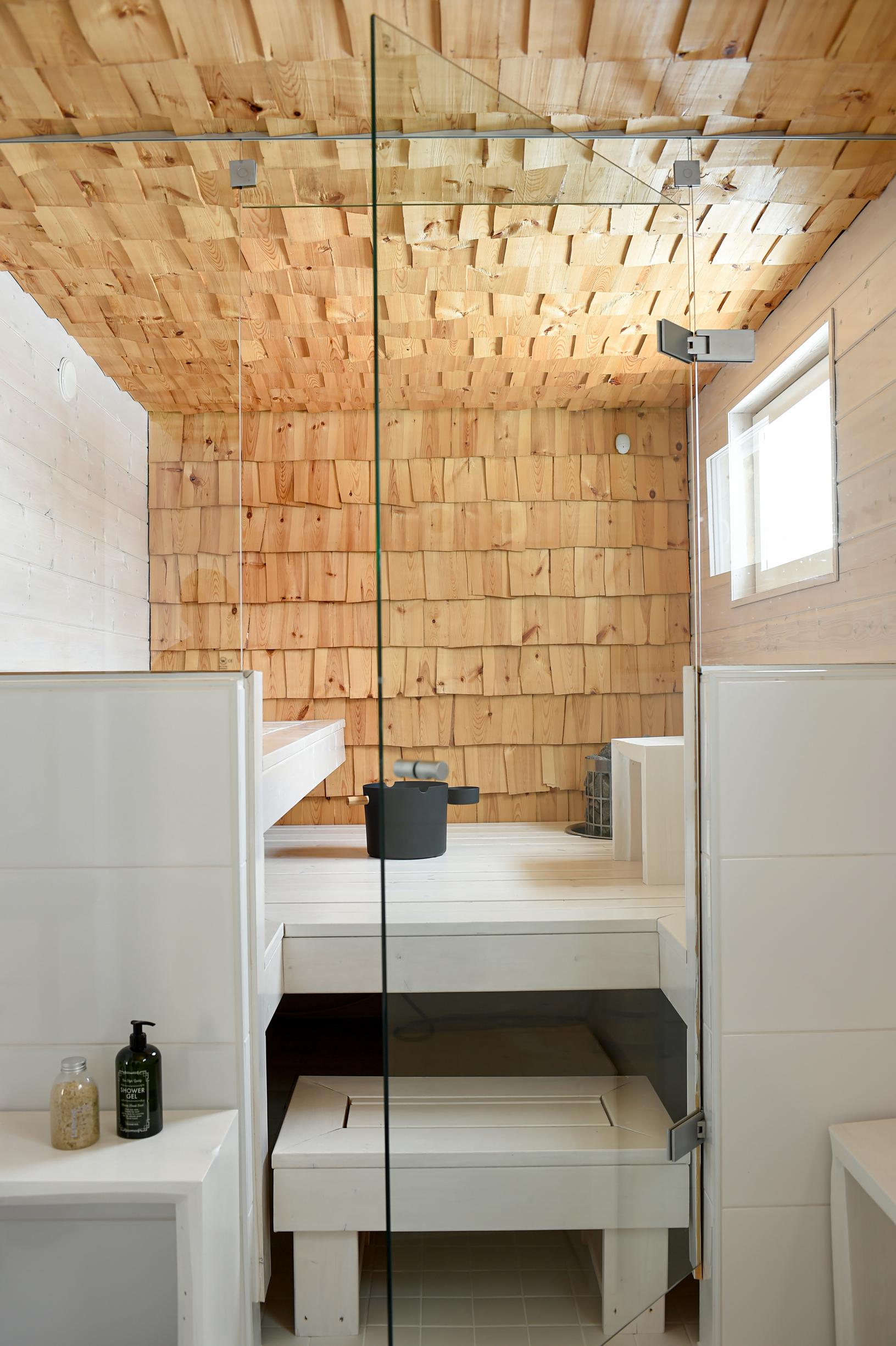 A sauna with wood shingle surfaces