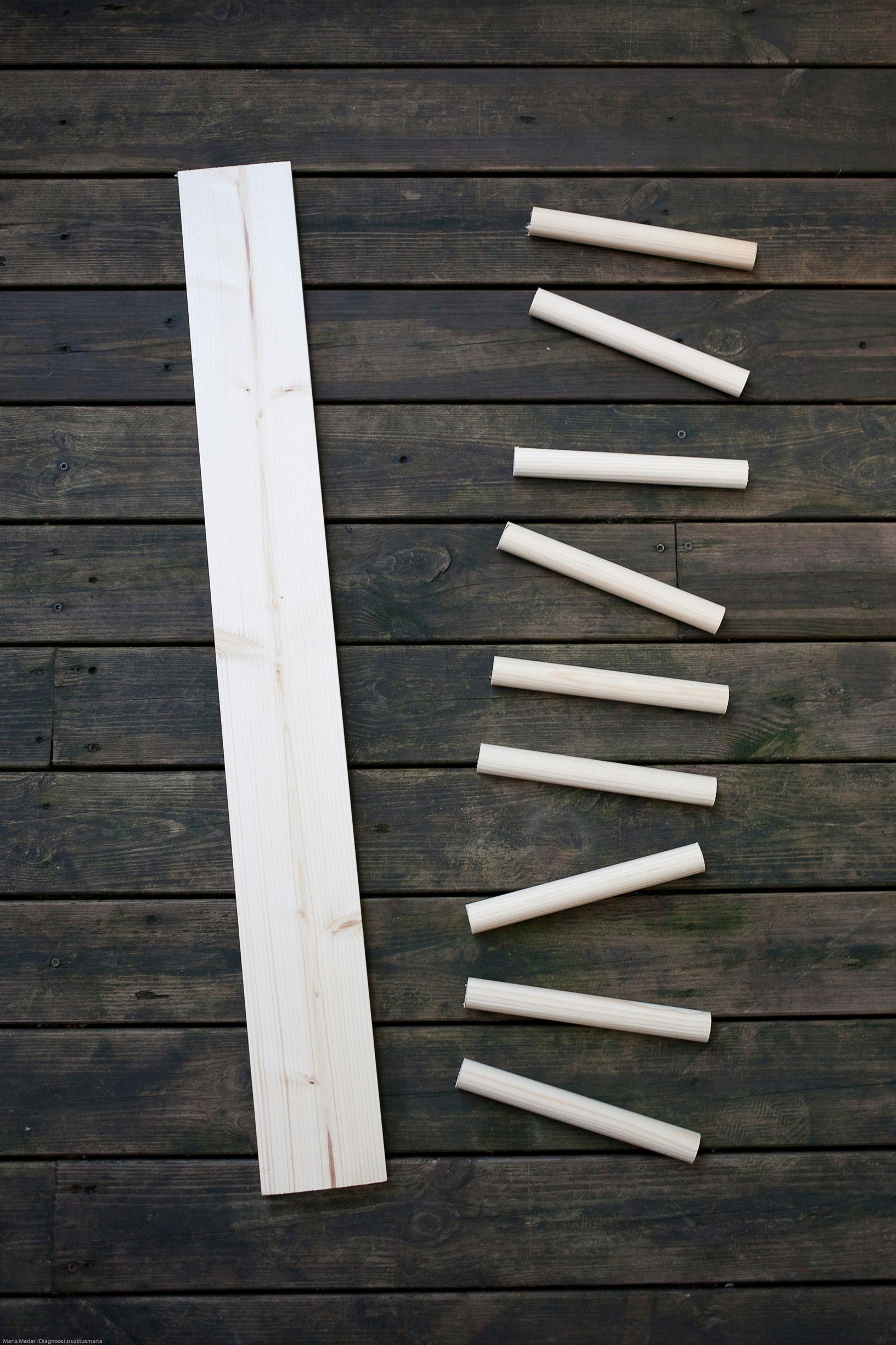 Step image showing the board and dowels cut from broom handles.