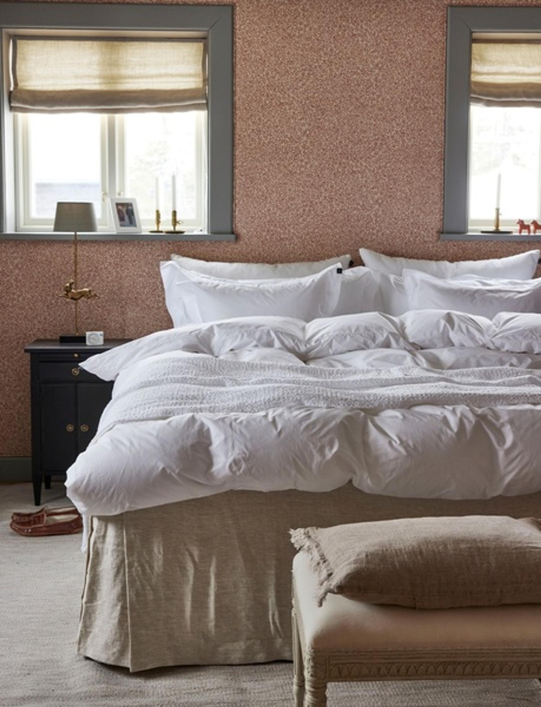 A solid-colored bed skirt on the bed.