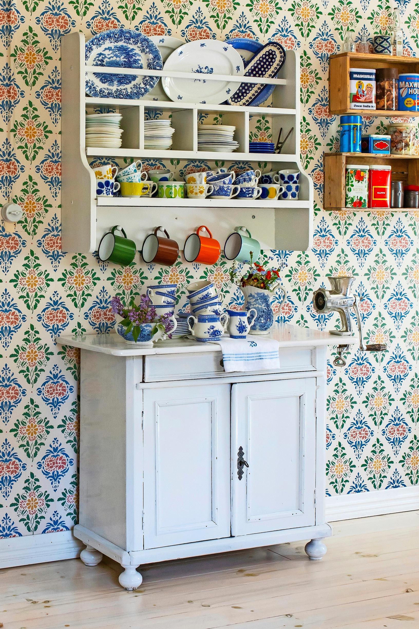 Vintage coffee cups and tins on an old open shelf and cabinet