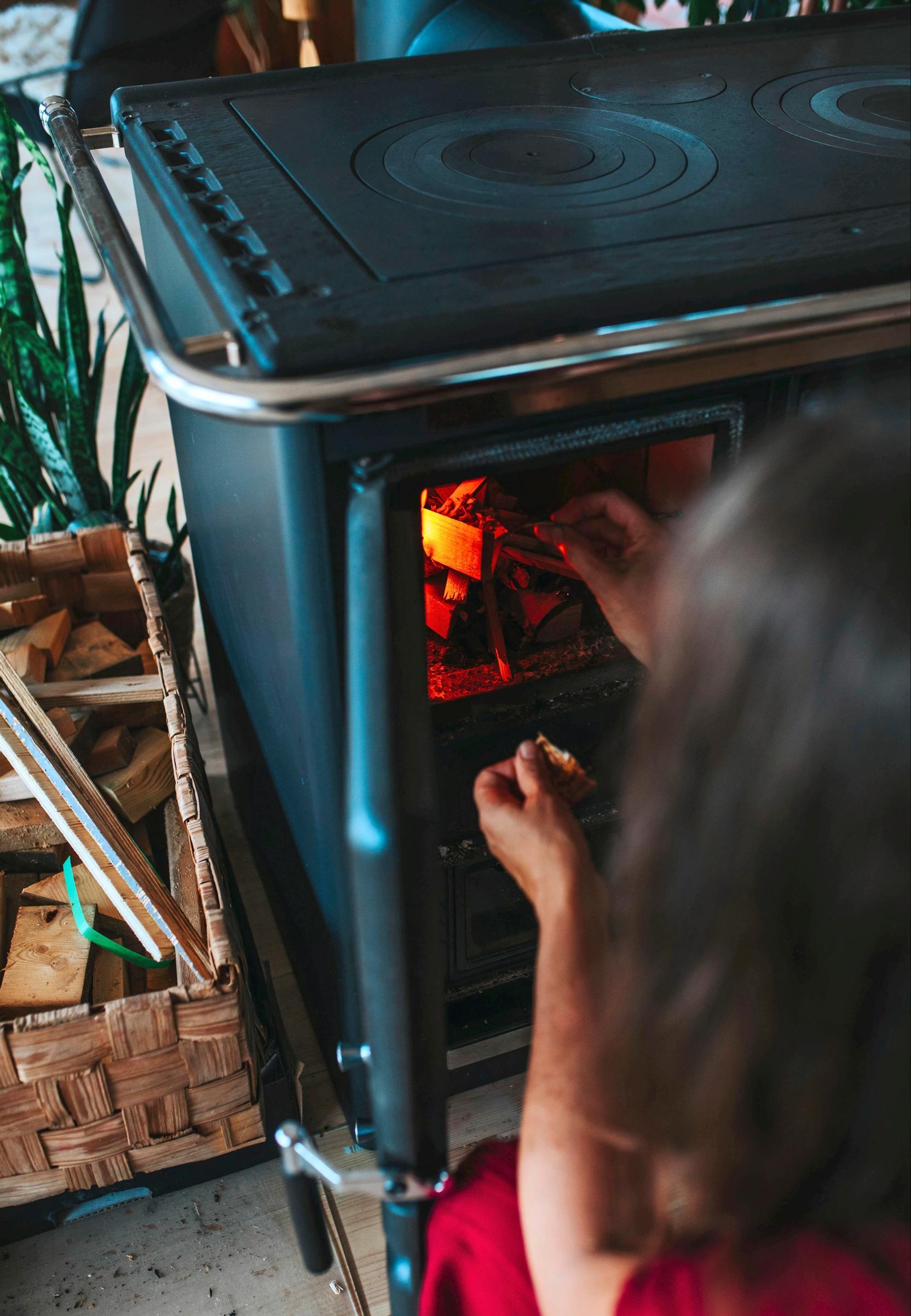 Kirsi Salo lighting the stove