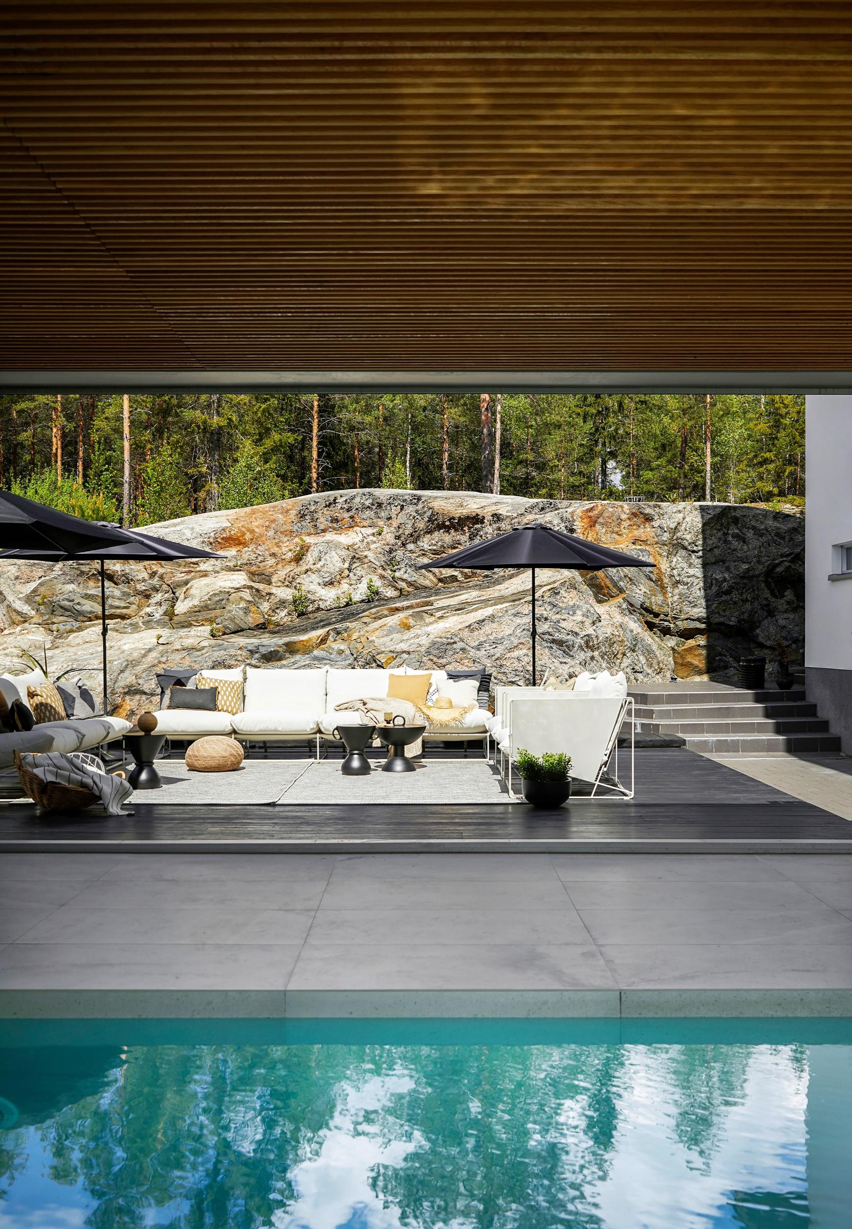 A patio area next to a rocky outcrop.
