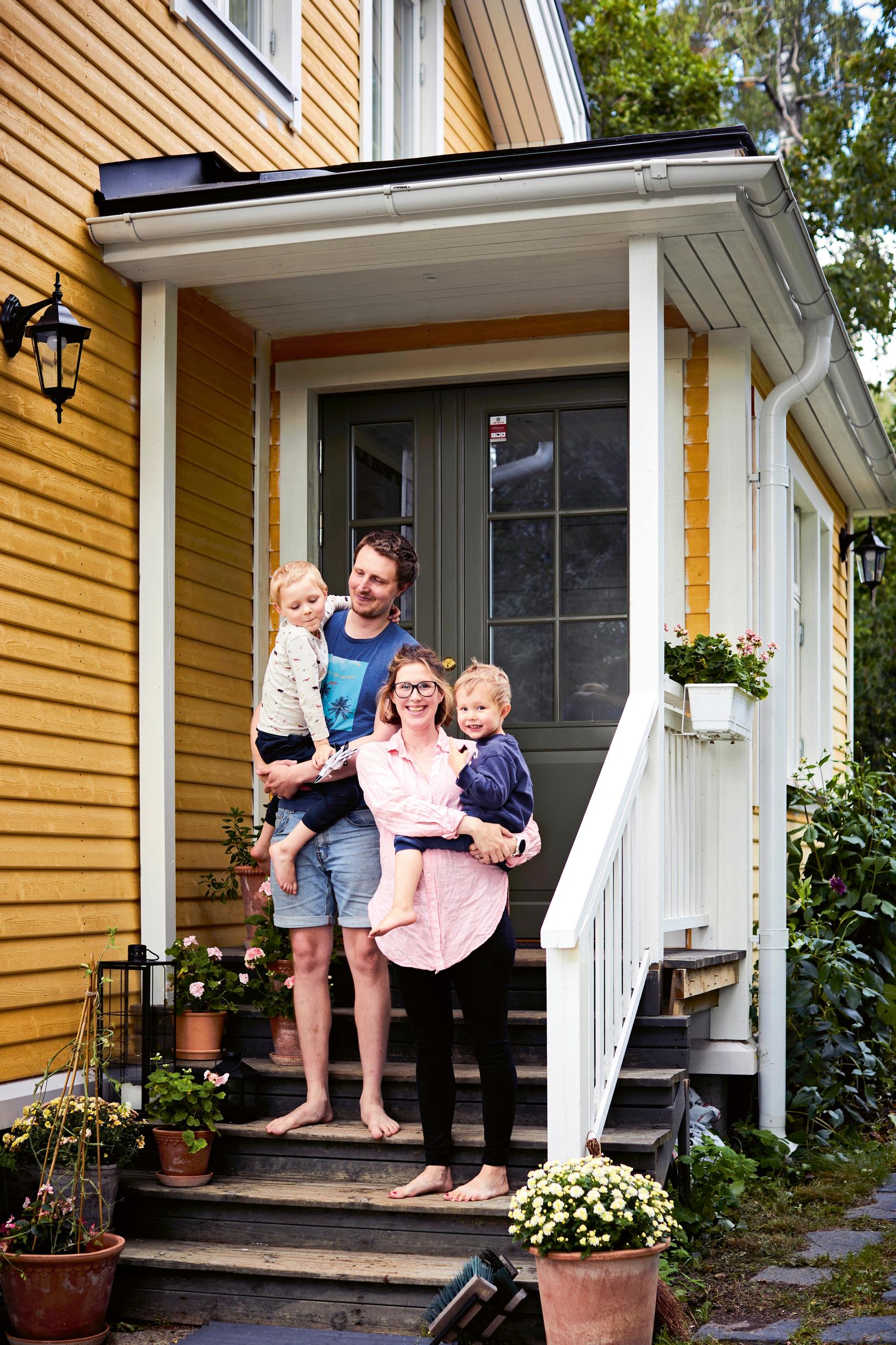 Family on the porch of the yellow house