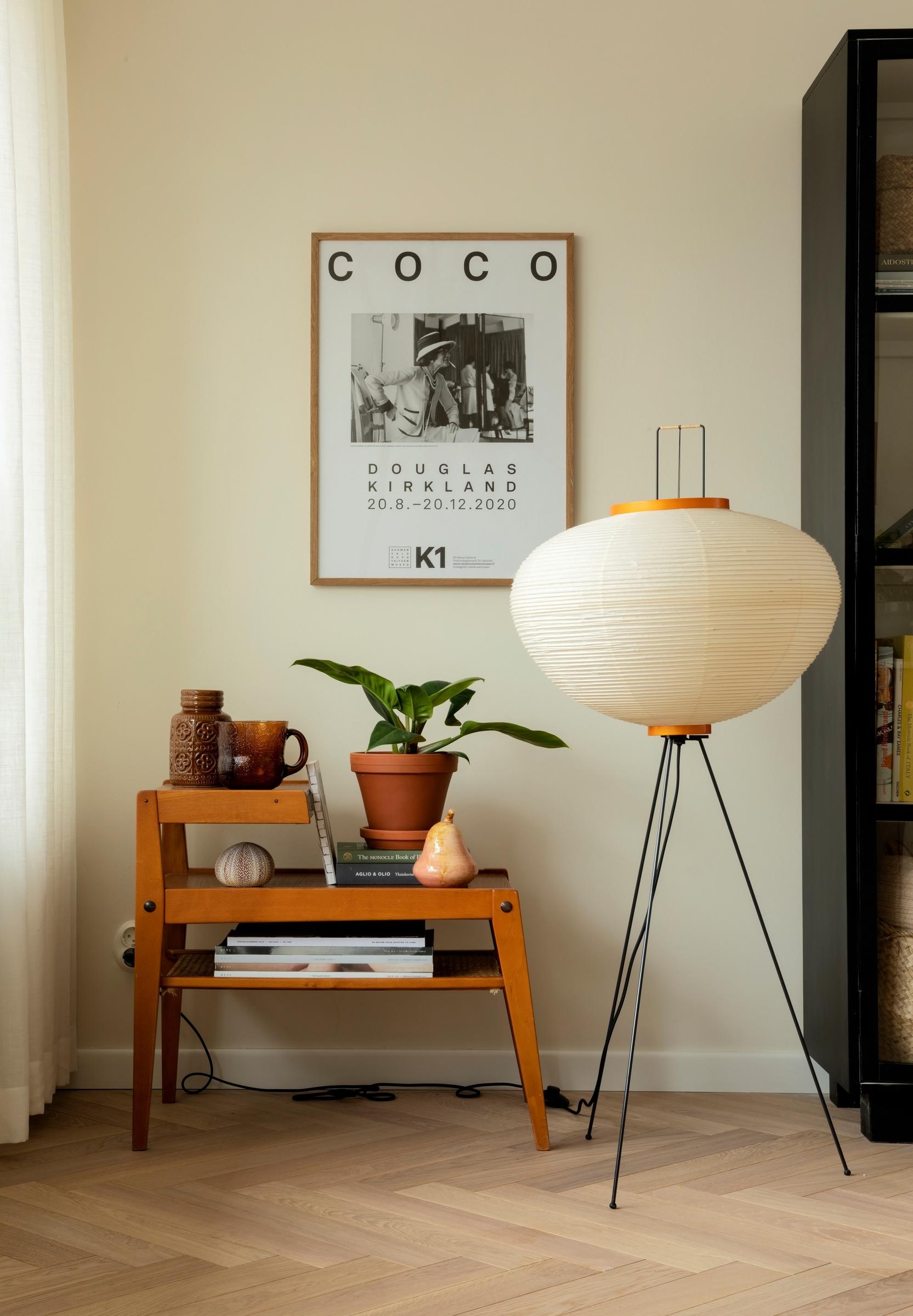 A rice paper lamp standing on legs.