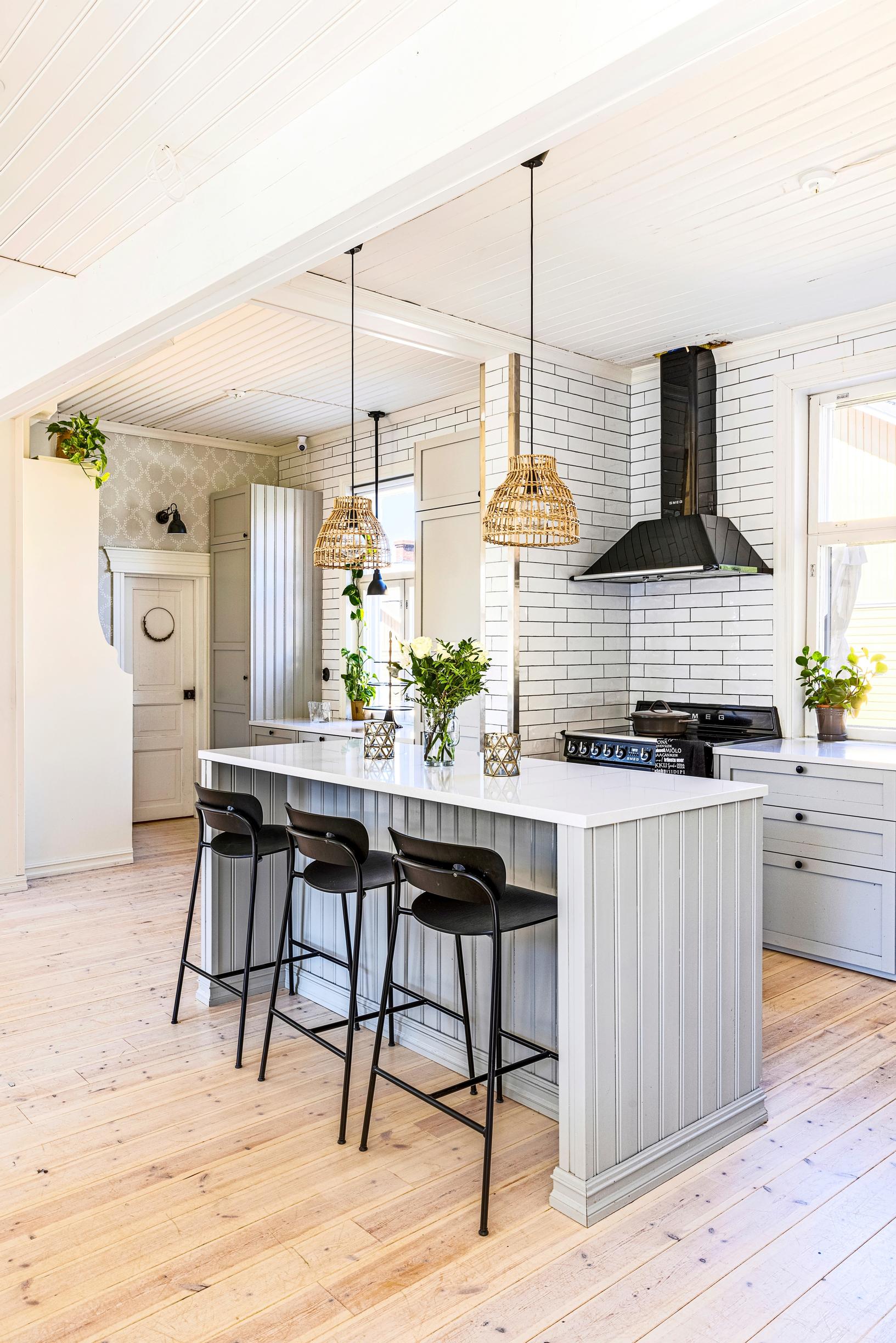 An old house kitchen with a beadboard-paneled island