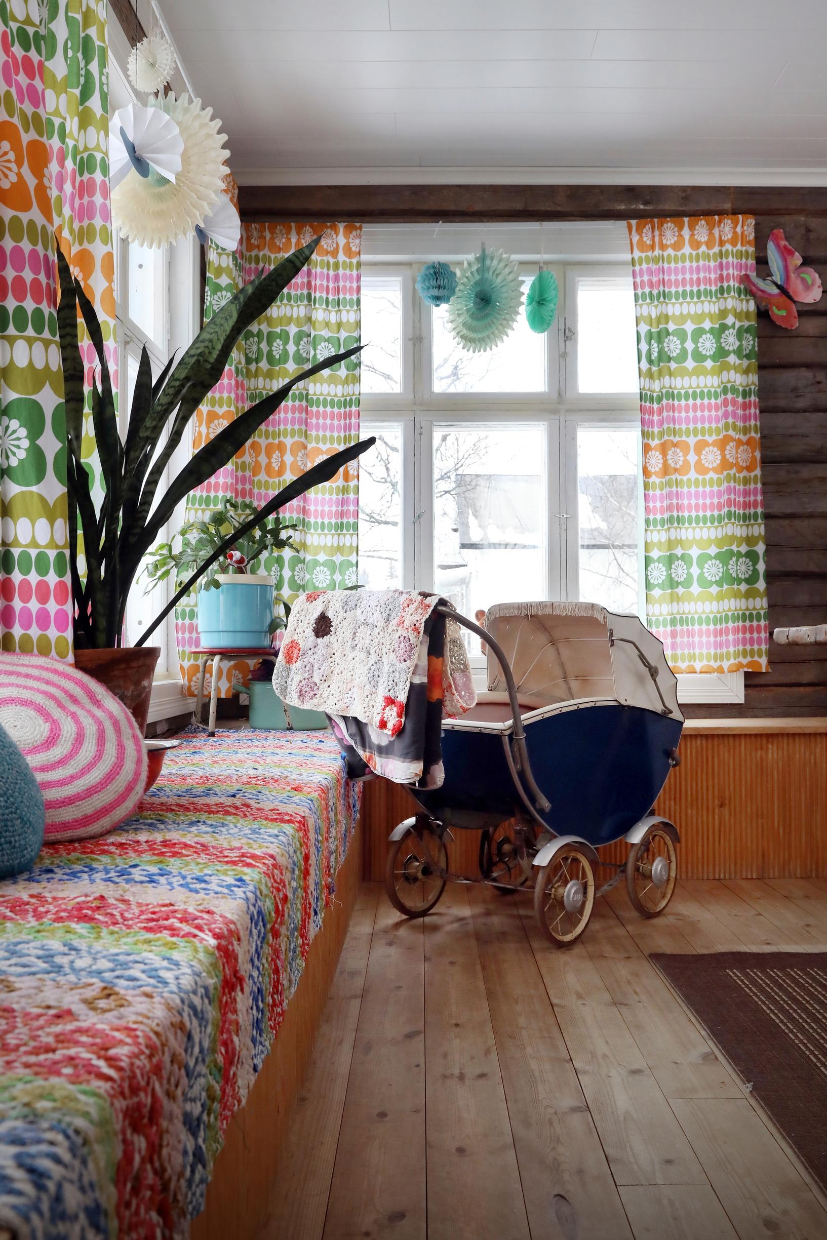 A window bench in the kitchen and old baby pram.