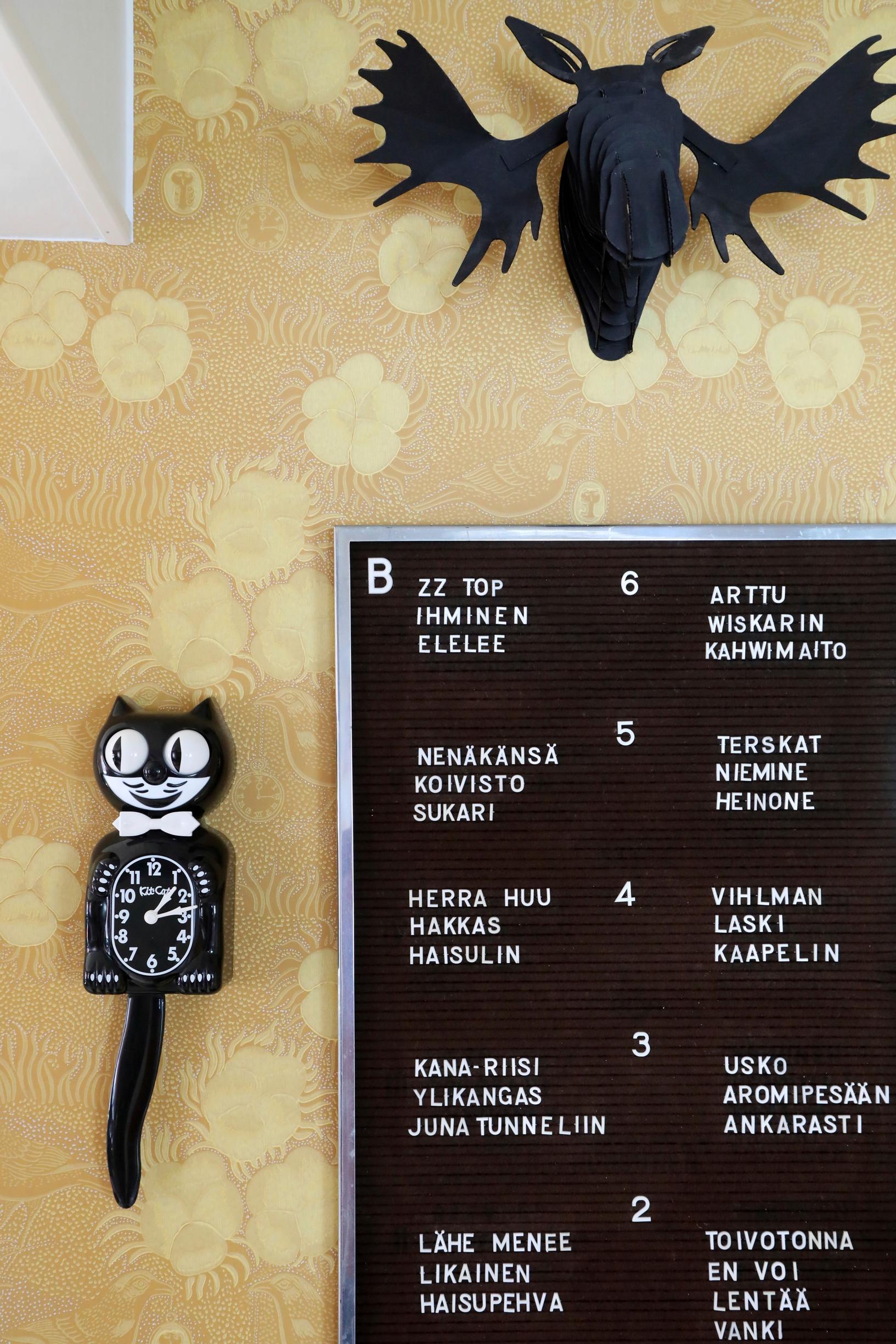 A Kit-Kat Clock and the stairway name plaque on the wall