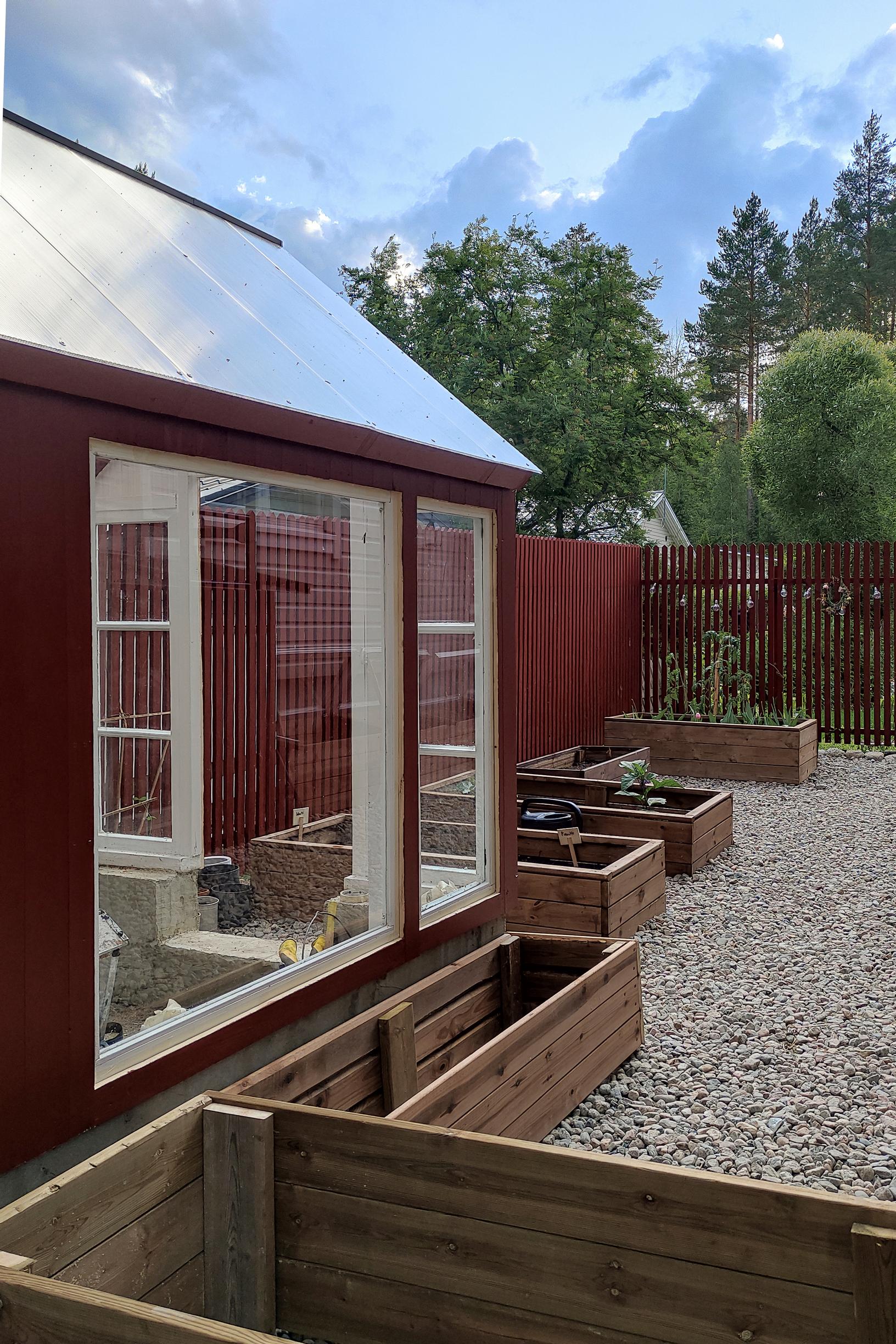 Raised beds alongside the greenhouse.