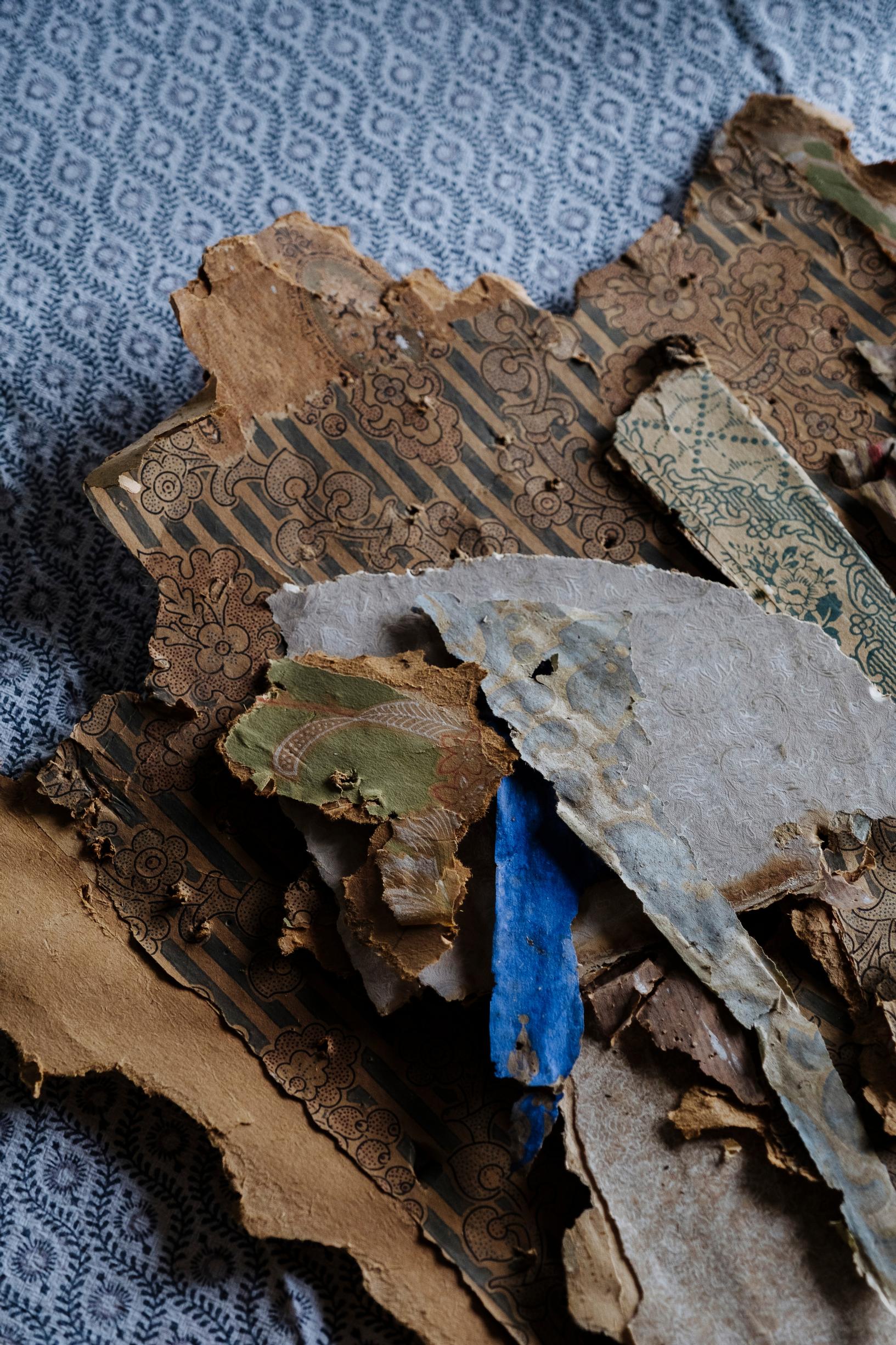layers of old wallpaper partly torn away