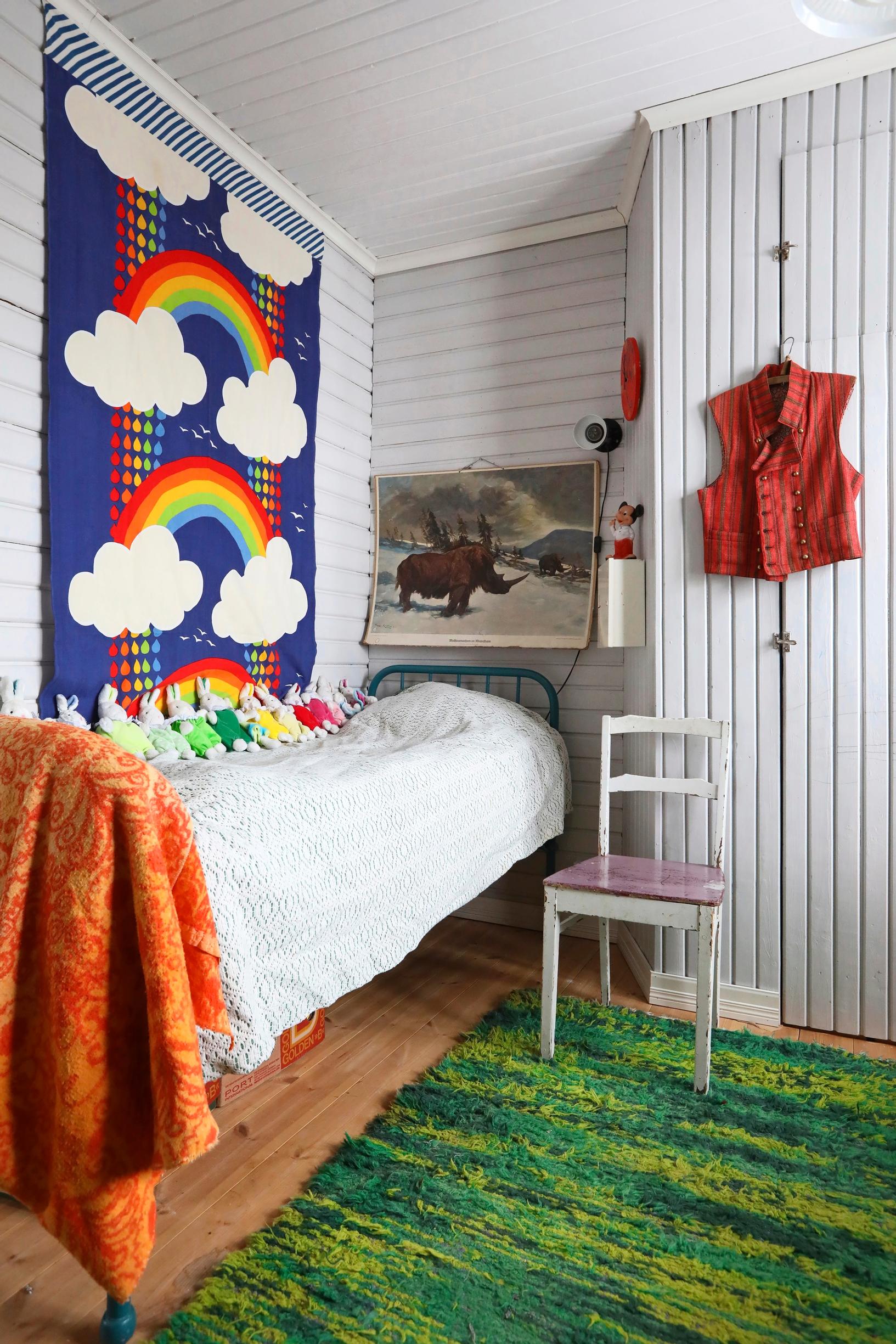 Ilja’s room, featuring a bold rainbow fabric on the wall.