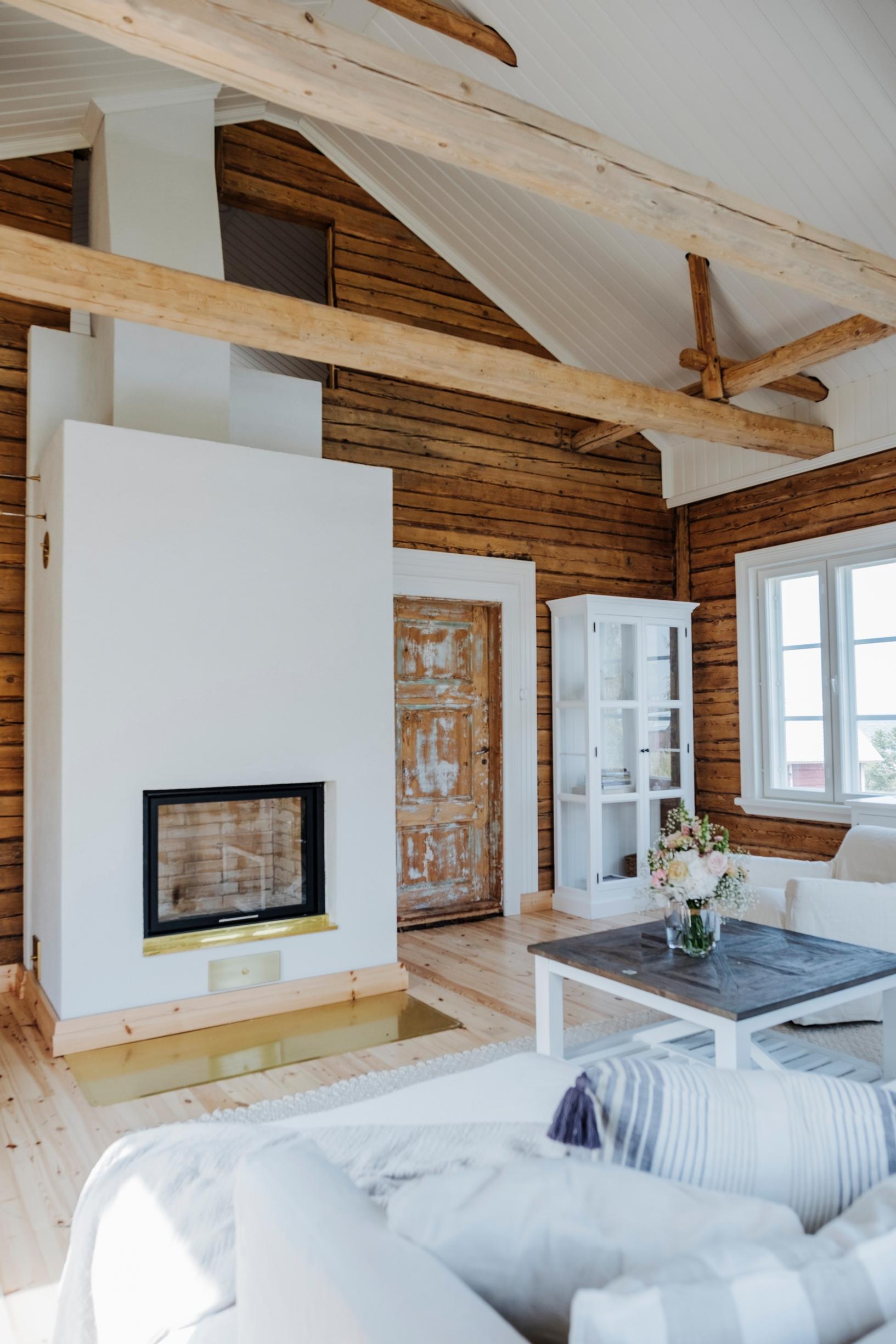 Living room with a large fireplace and opened intermediate floor